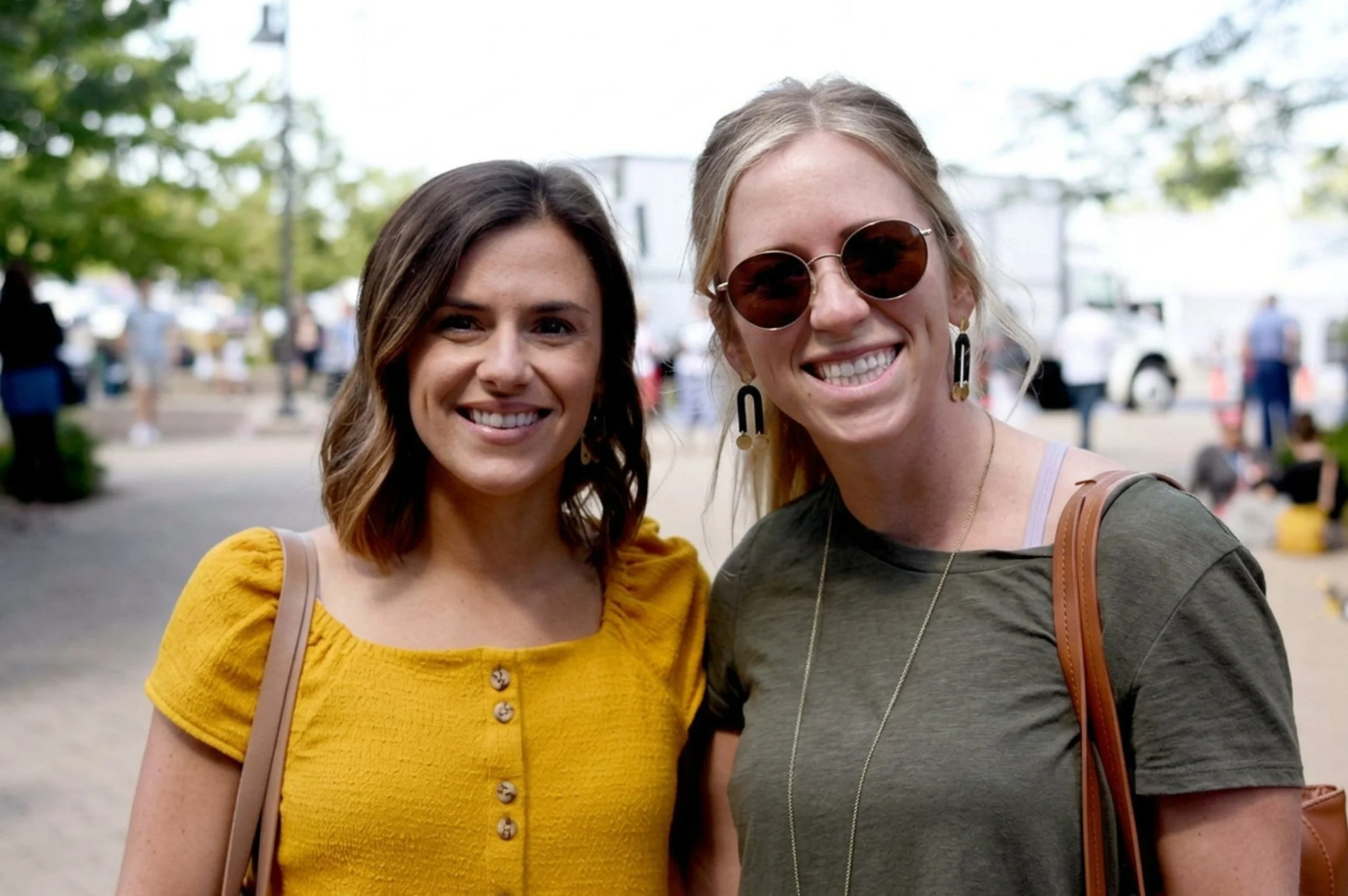 Women leaders smiling as they attend an event.