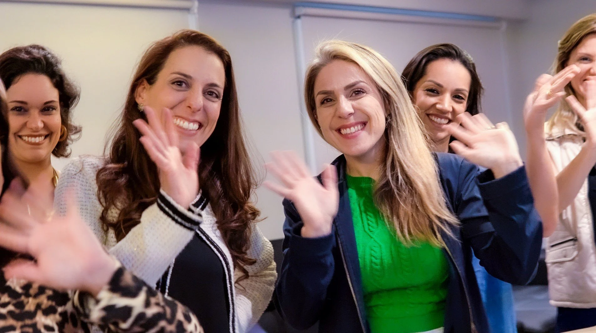 Three women leaders smiling and enjoying a leadership event.