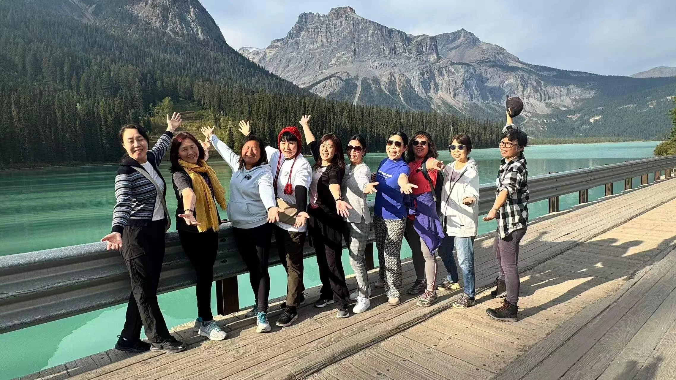 Woman gathered at Calgary and standing in front of a river celebrating their leadership development.