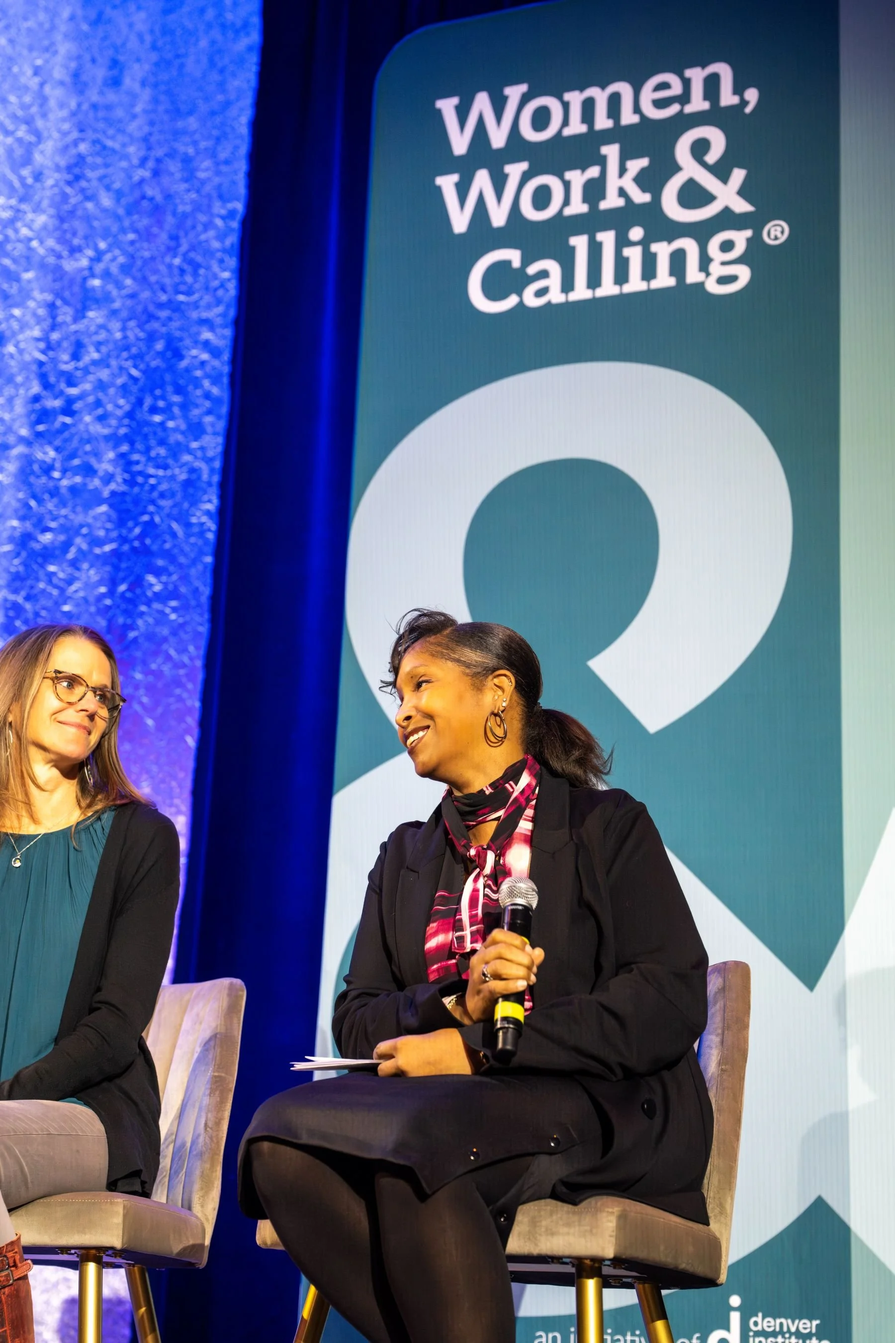 Women presenting from stage at a Women Work and Calling leadership event.