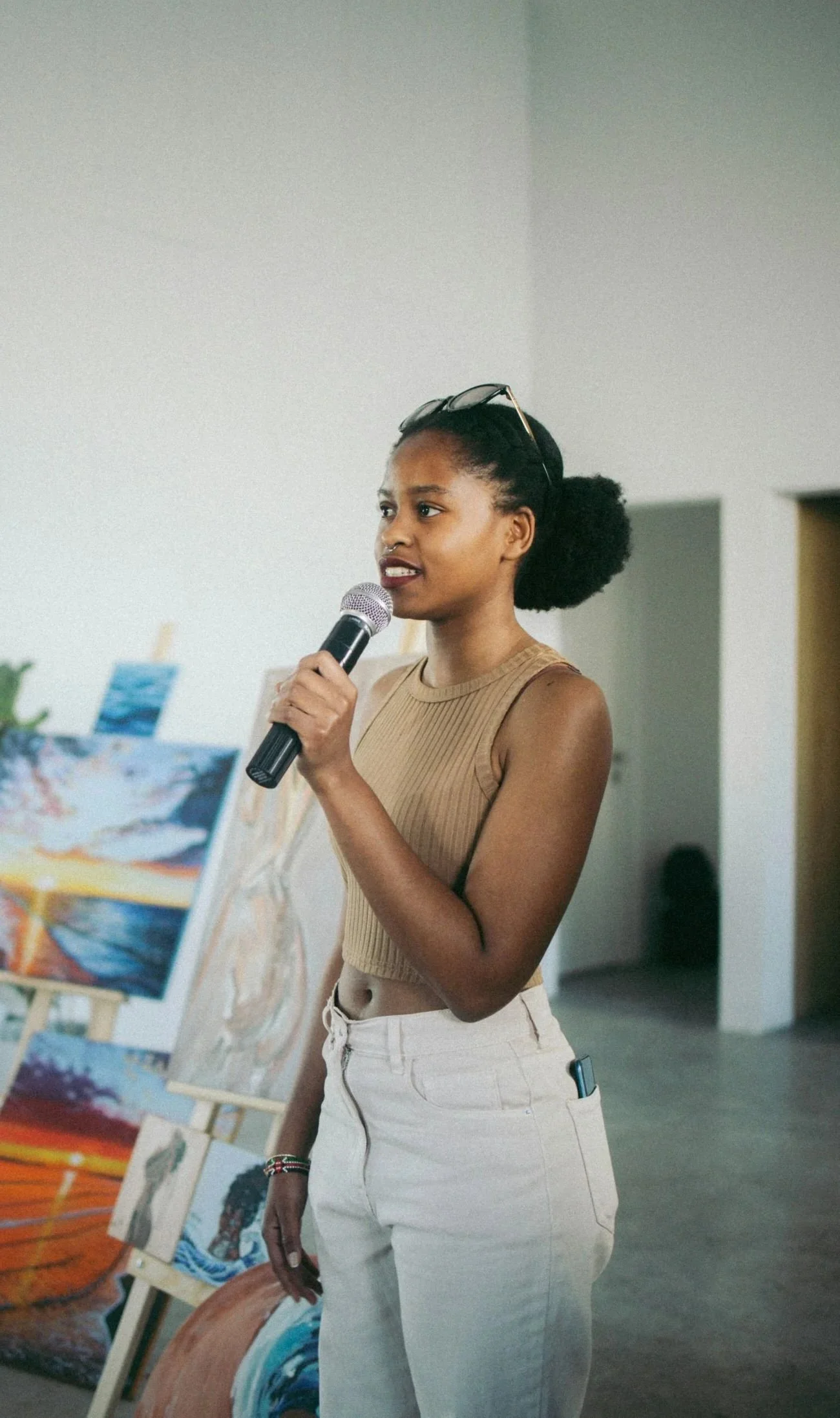 A younf woman leader sharing her story at an event.