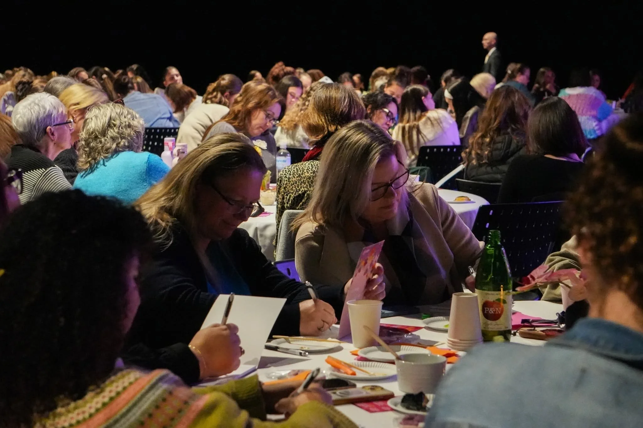 Women leaders writing at an Amanda Viviers workshop.
