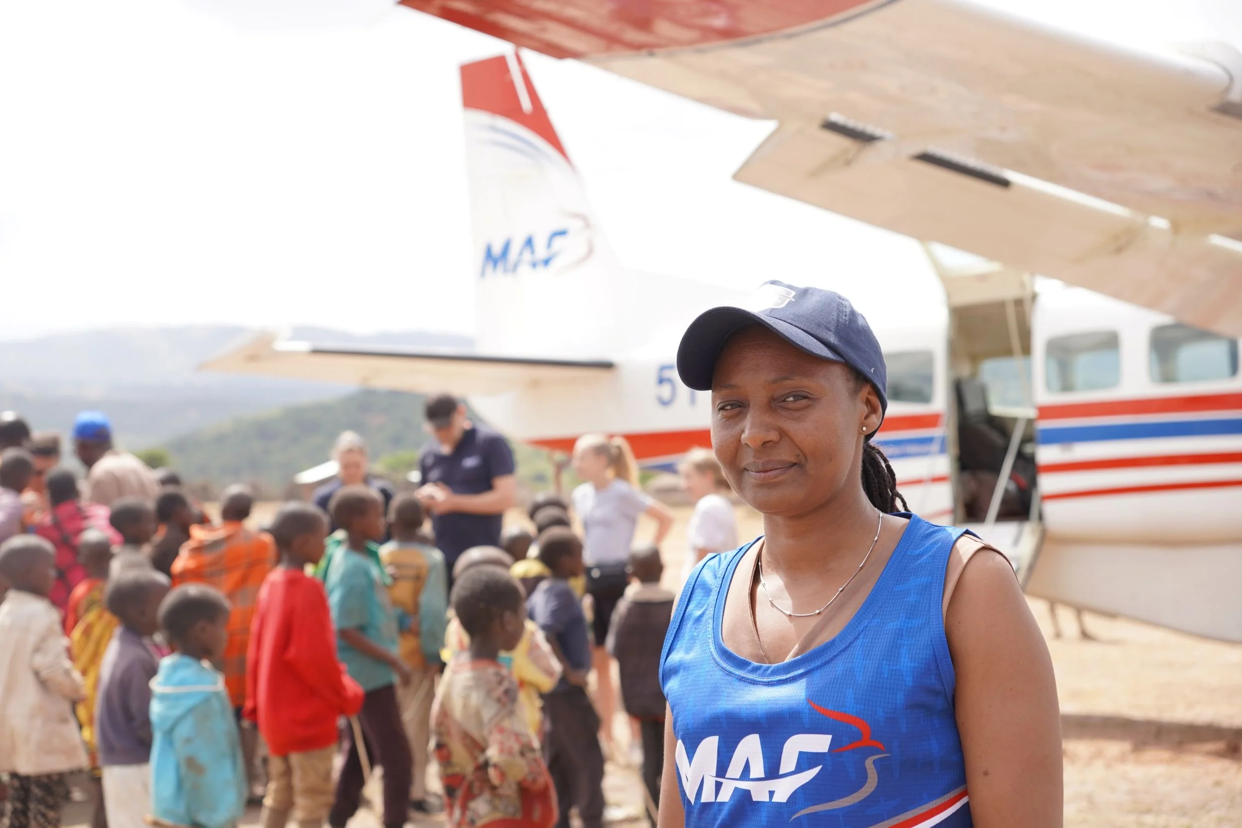 Flight commander Faith Susan from Mission Aviation Fellowship, standing in front of her plane.