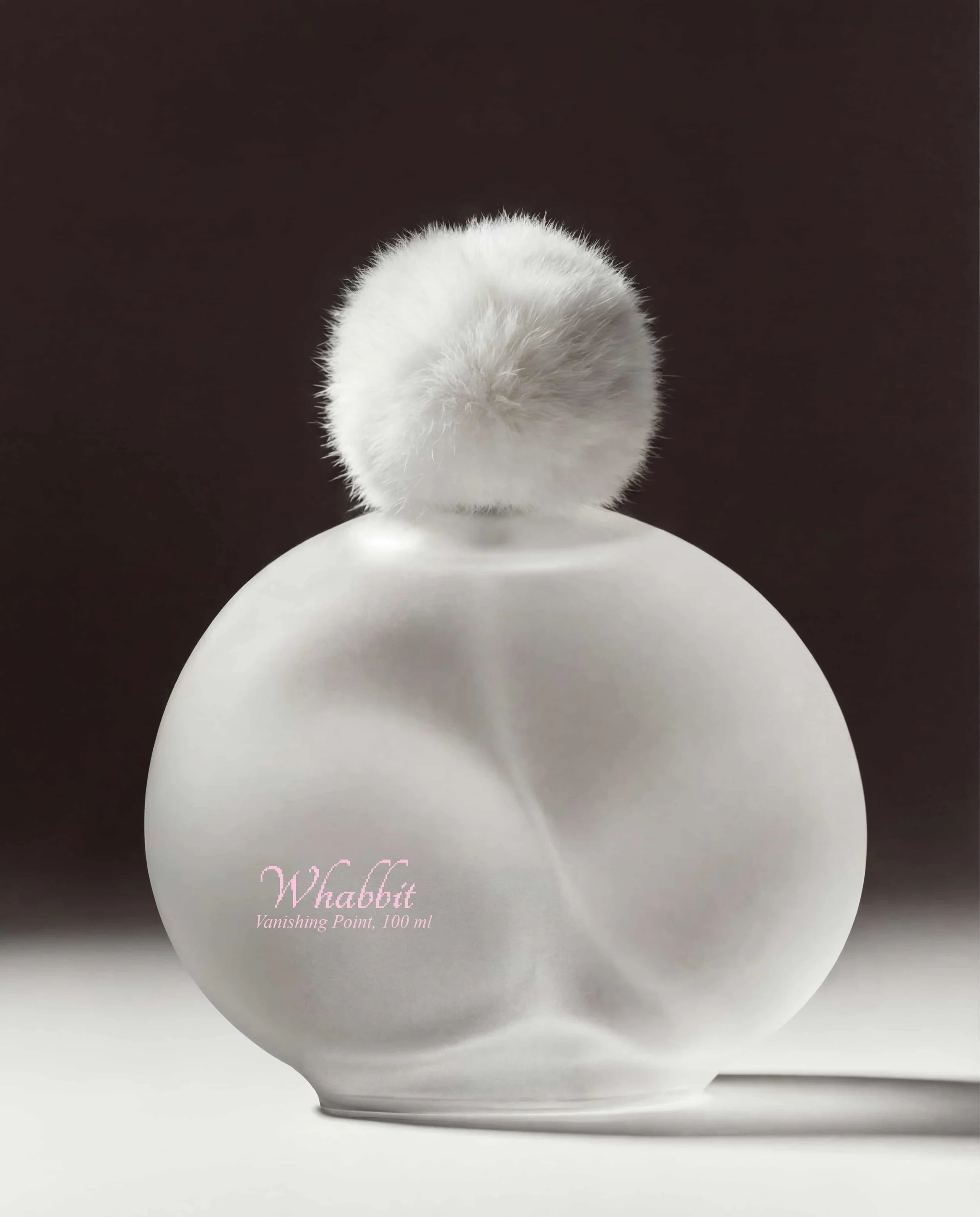 Close-up of a white, fluffy cosmetic puff atop a white jar labeled 'Whabbit Vanishing Point, 100 ml' on a black background.