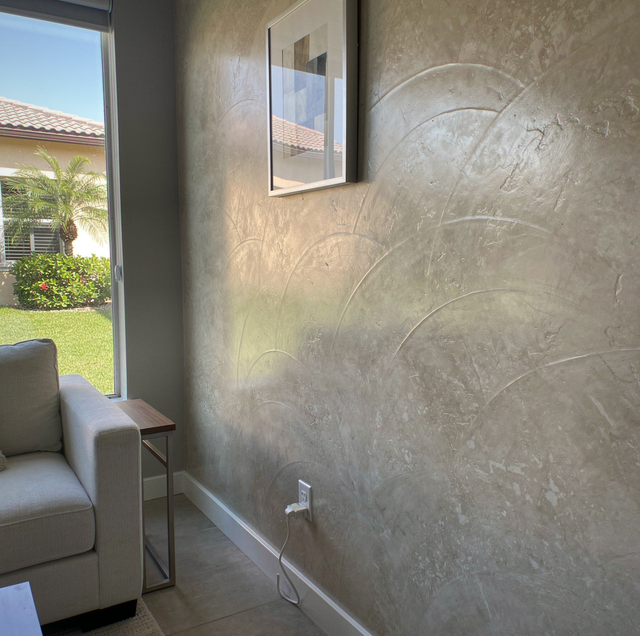 Hand applying polished venetian plaster to wall with trowel
