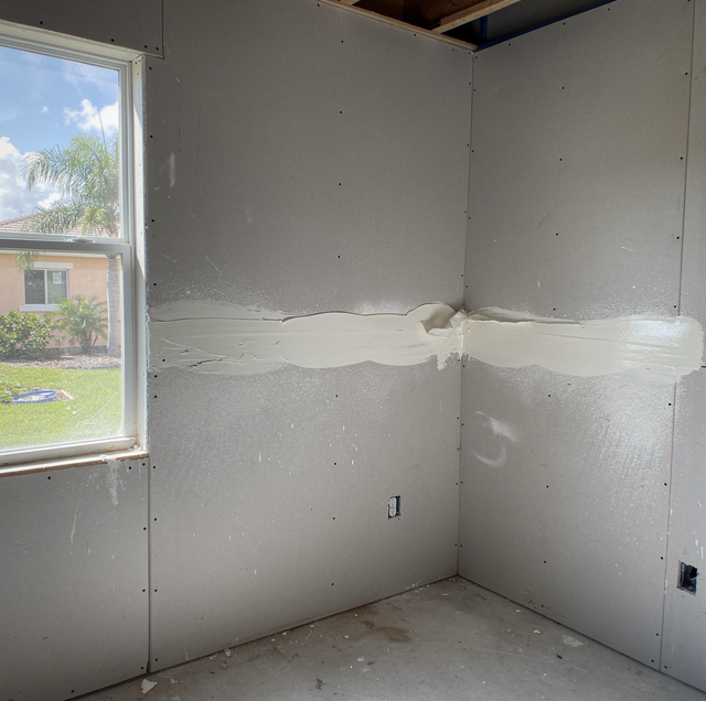 Fresh drywall seams covered in wet joint compound