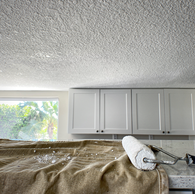 Paint roller pulling popcorn ceiling texture loose
