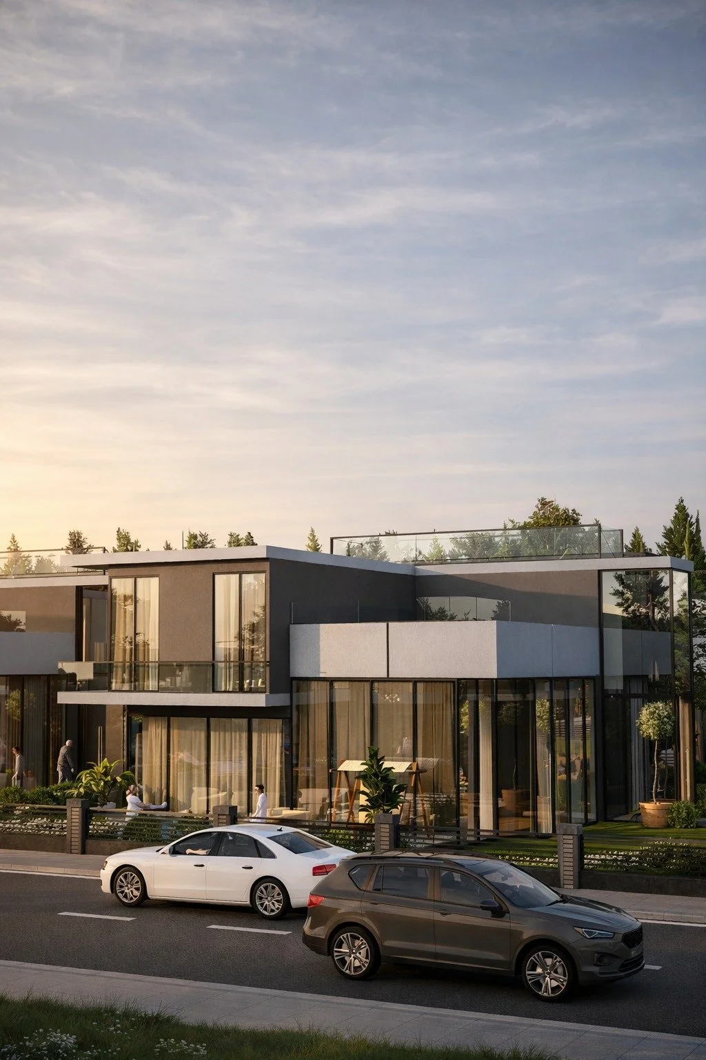 Modern multi-story residential building with large glass windows and balconies, cars parked on the street in front, trees in the background, under a partly cloudy sky.
