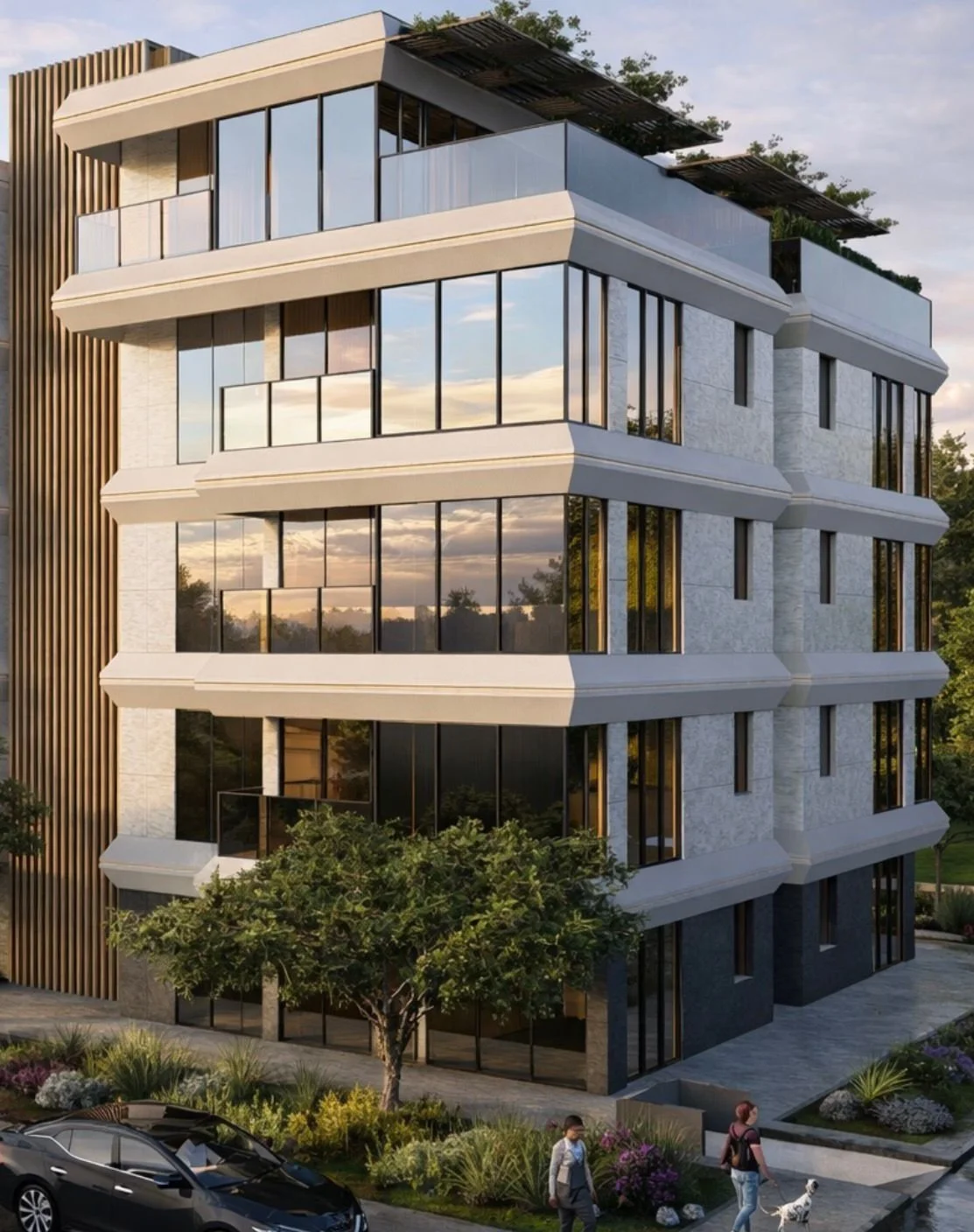 A modern, multi-story residential building with large glass windows and white exterior walls, surrounded by trees and landscaping, during sunset.
