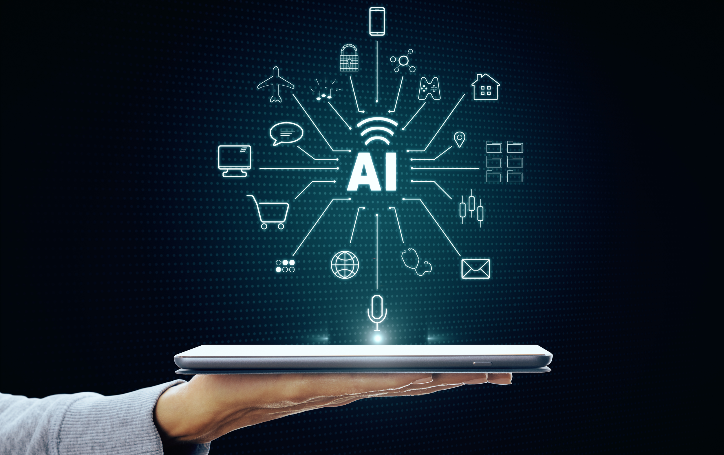 A hand holding a tablet with digital icons representing artificial intelligence and connectivity, including Wi-Fi, a globe, a shopping cart, a computer monitor, and various other symbols, set against a dark background with glowing lines.