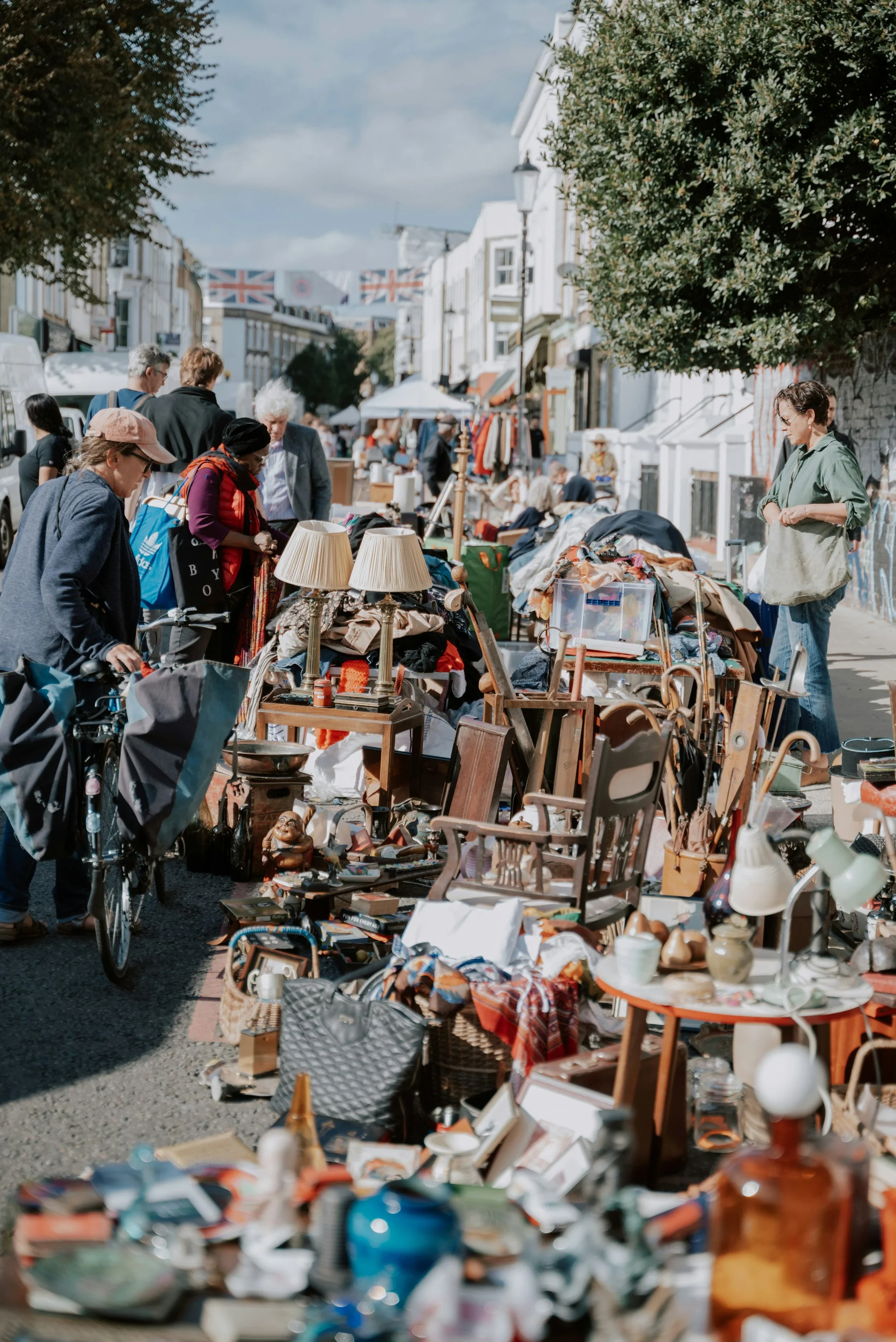 Busy outdoor London antique and flea market filled with vintage furniture, collectibles, décor, and treasure hunters.