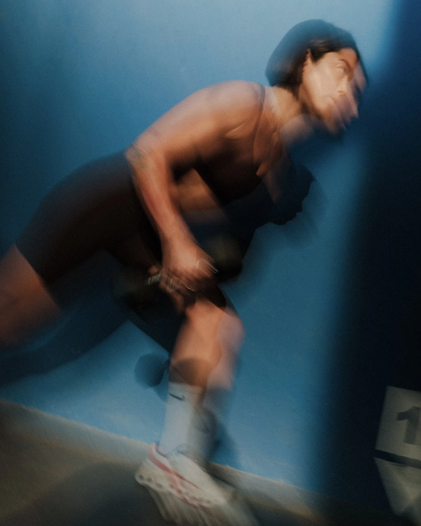 Claris doing a single leg exercise, lunge with kettlebell.