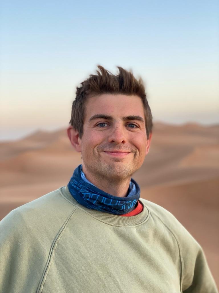 Young man smiling in desert dunes