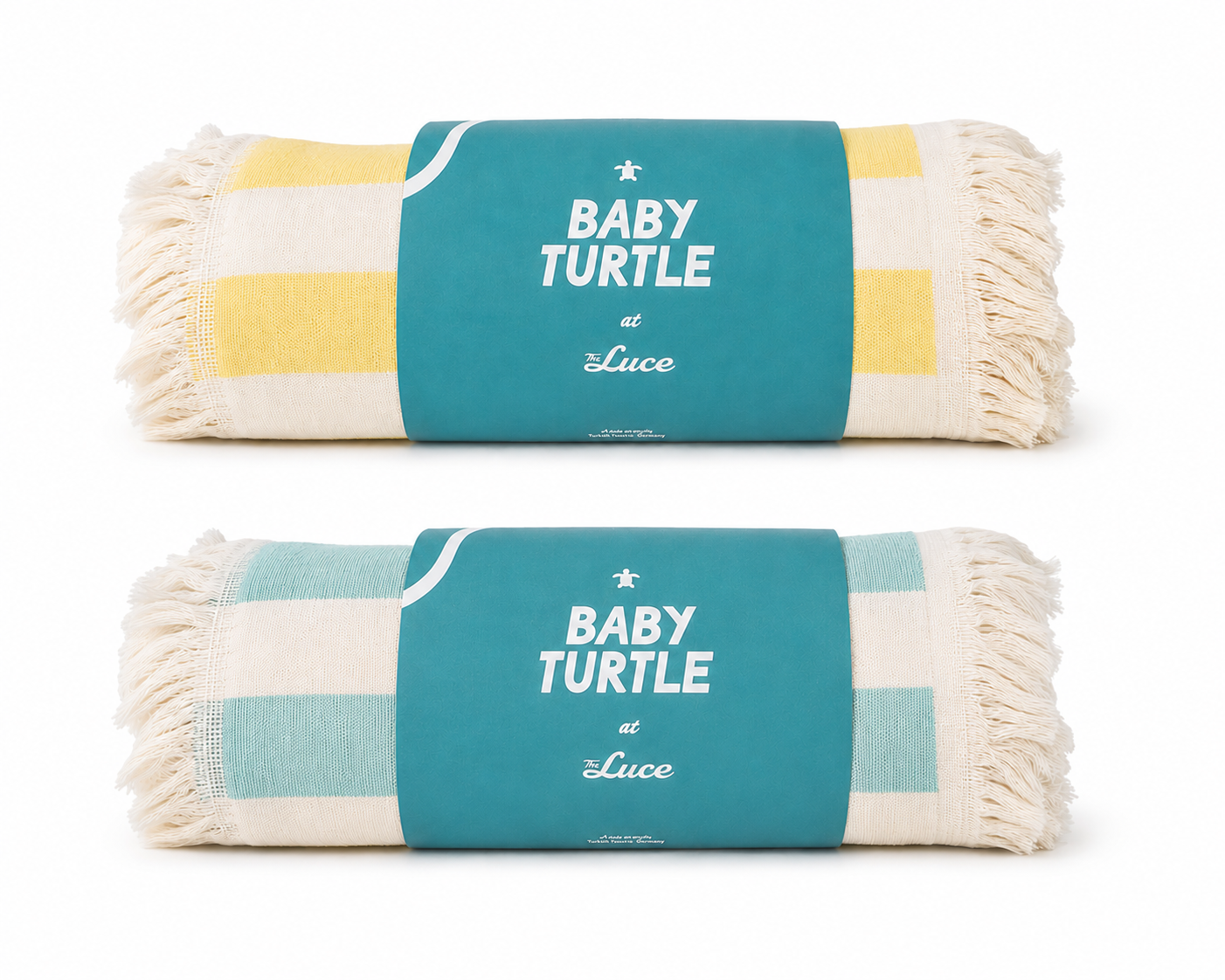Two rolled woven beach towels with blue labels that say "Baby Turtle at the Luce", one with yellow and white stripes and the other with teal and white stripes.