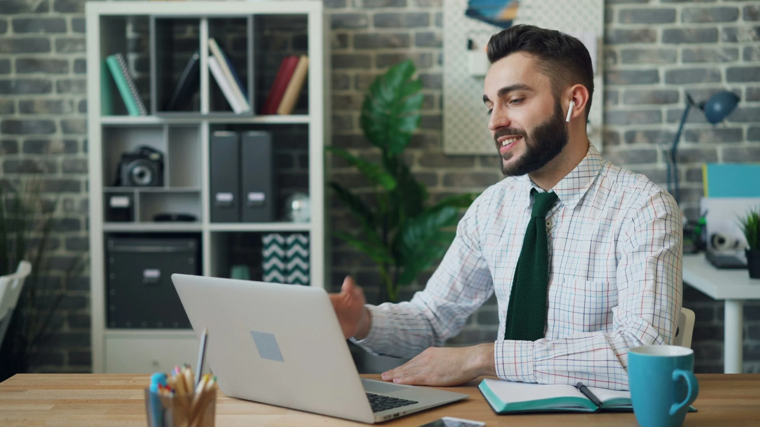 Business manager working on a laptop while planning an office relocation with MoveSolved.