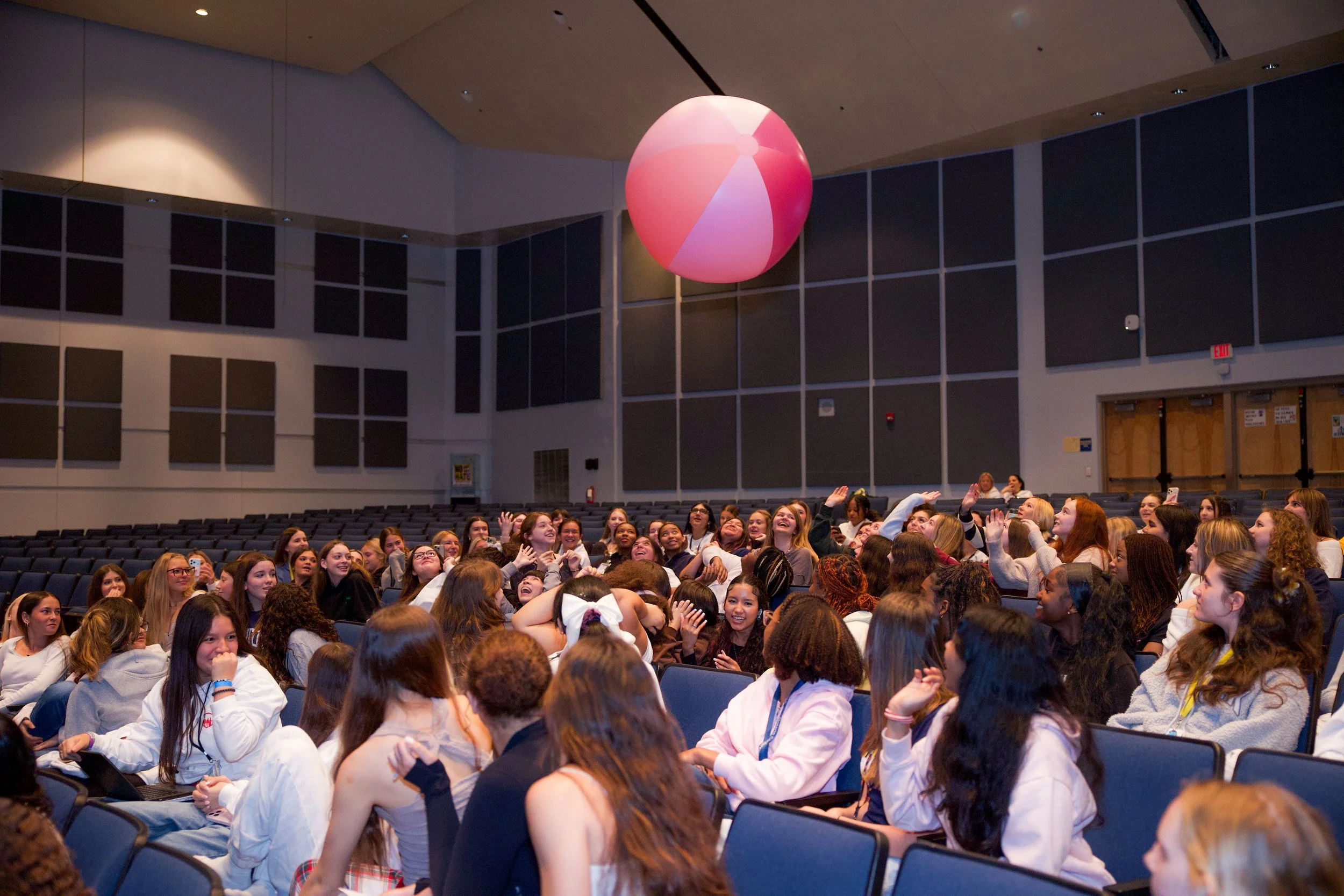 Empower the Girl audience members engaging with a beach ball to teach them the power of confidence.