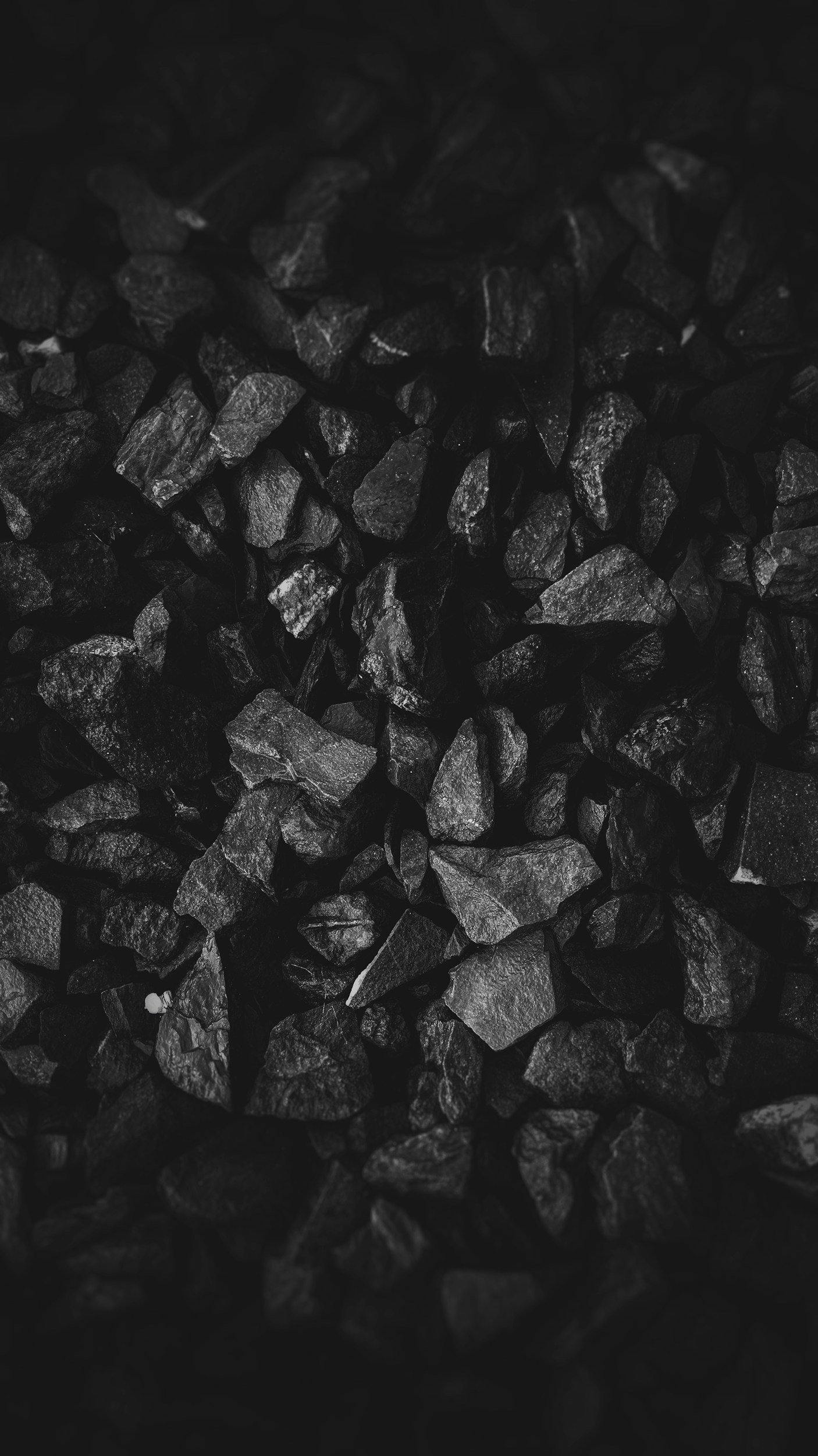 Close-up of small, irregularly shaped black rocks or gravel.