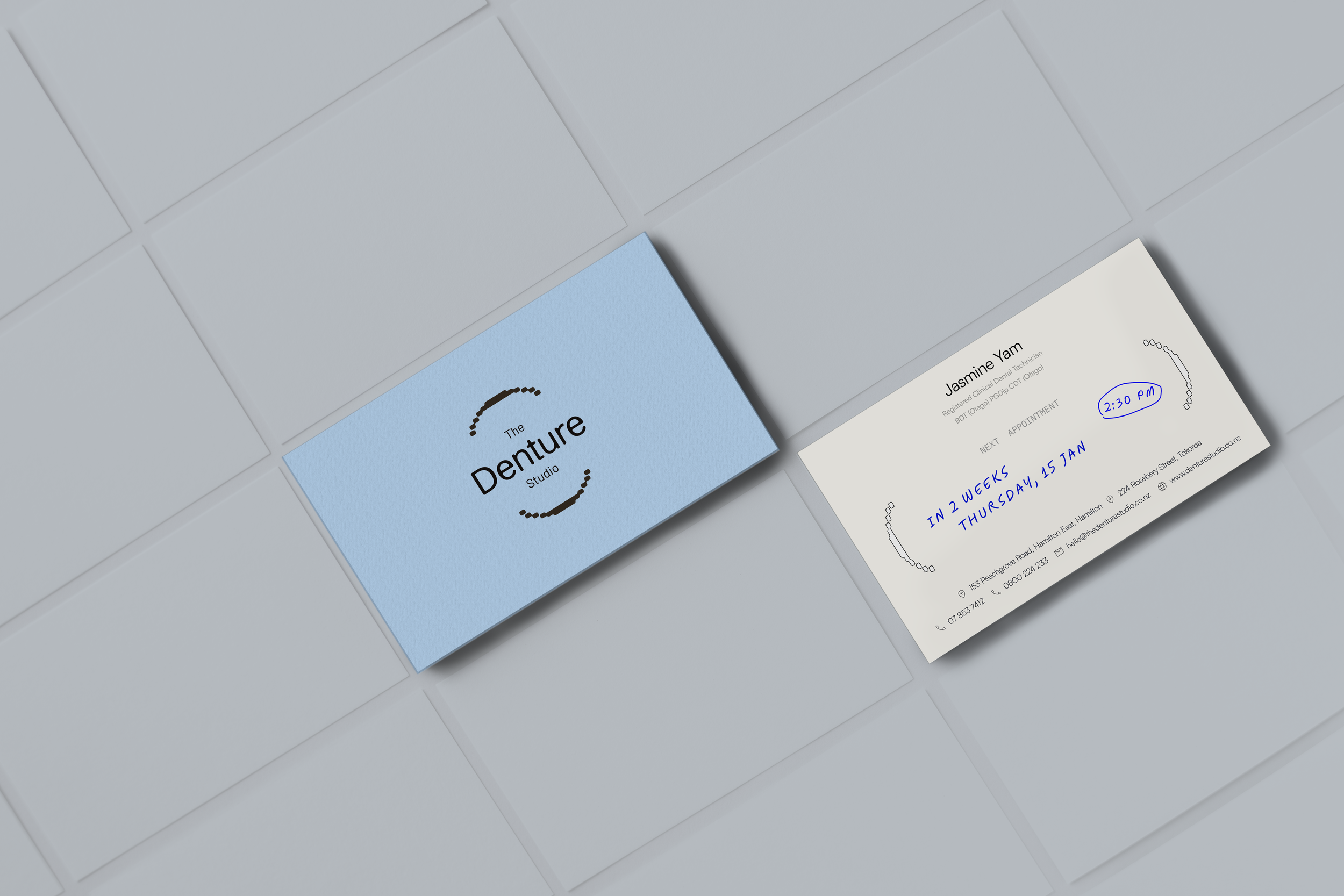 An image of The Denture Studio's business card front and back