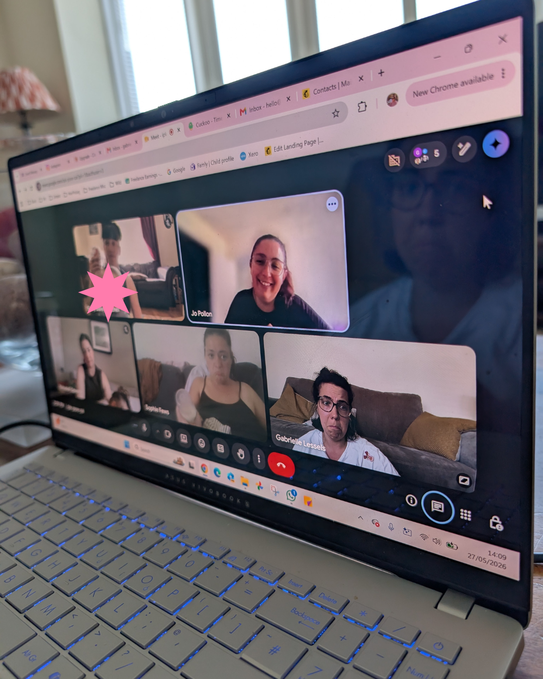 Laptop screen showing a video call with five women participating in a virtual meeting.