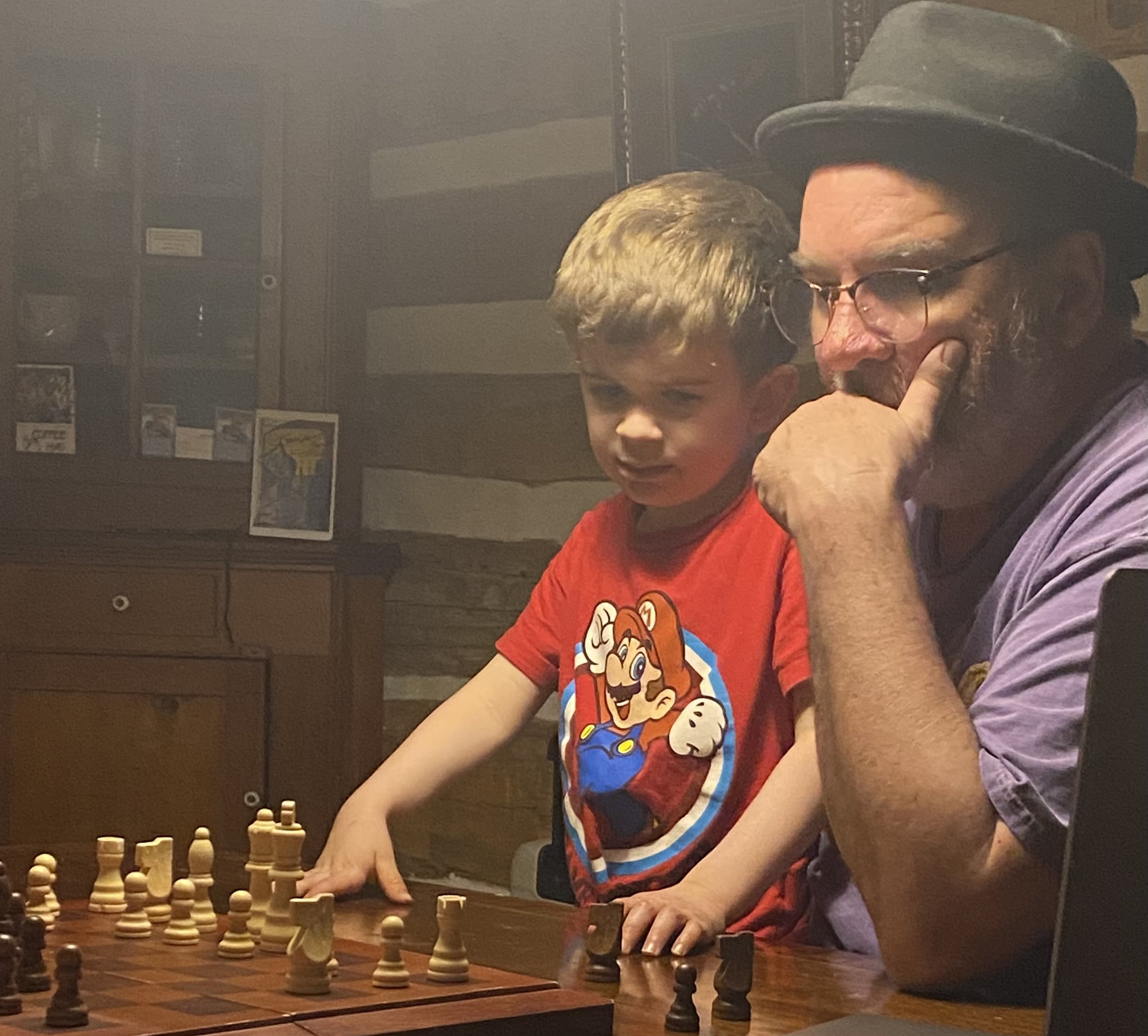 Joe and Grandson Joey at a chessboard.