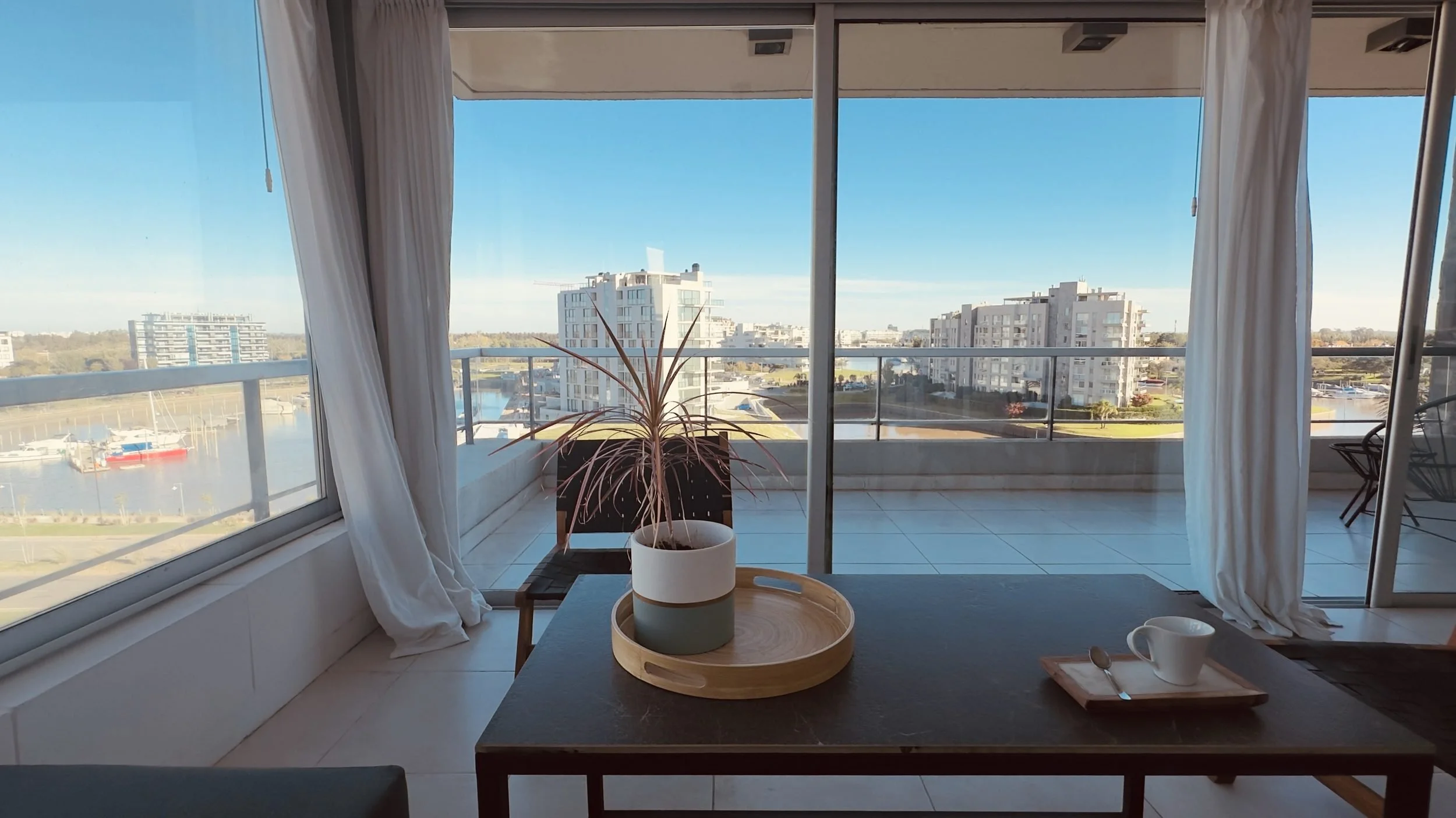 Bright living room with panoramic river views at Qbay Yacht