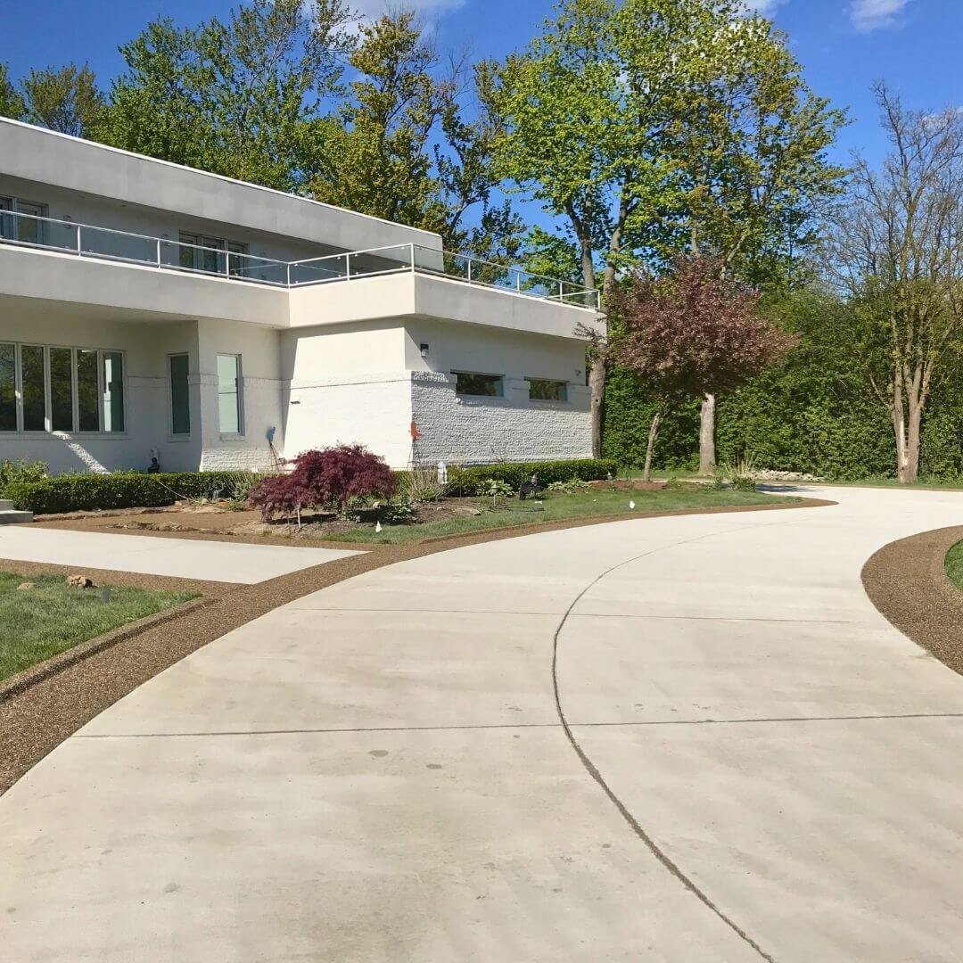 front of a home with a new concrete driveway