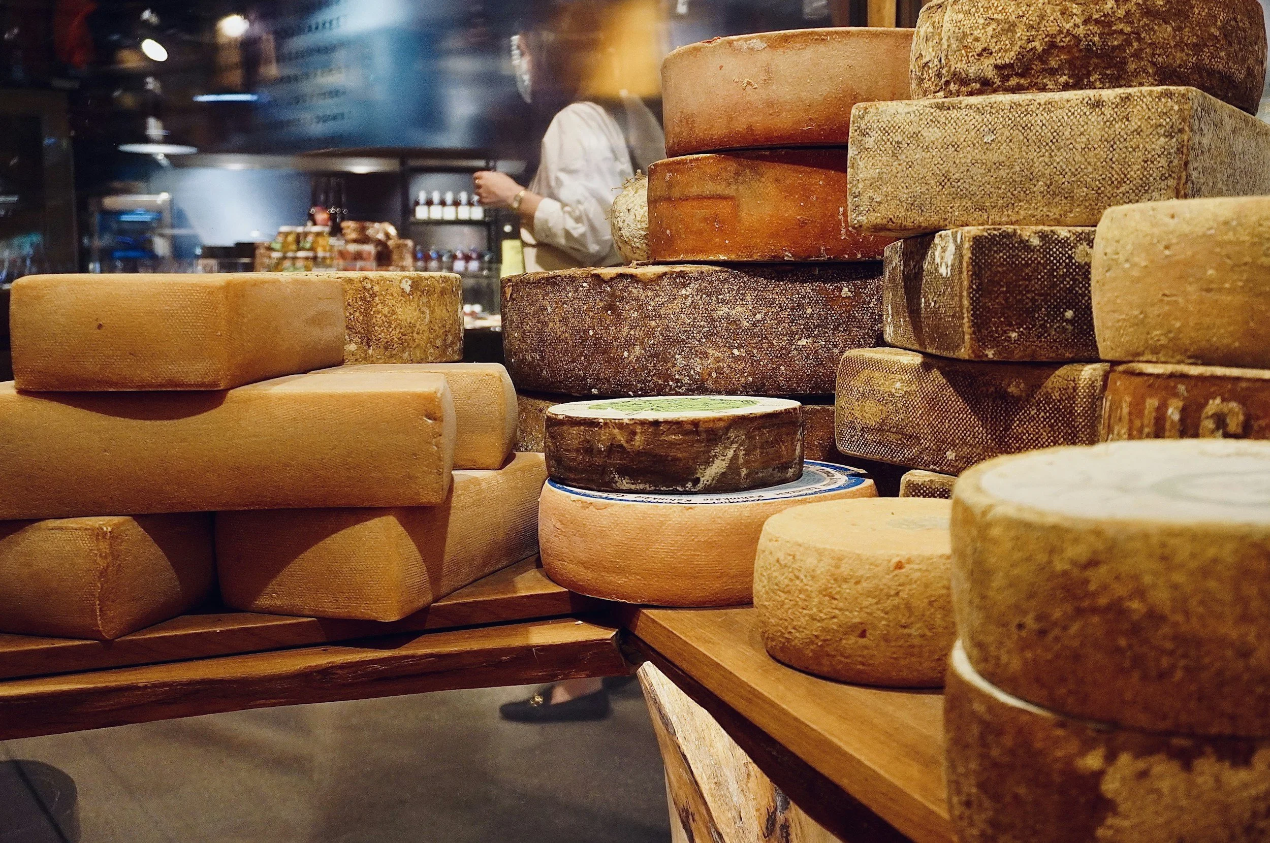 image of different cheeses displayed in a shop