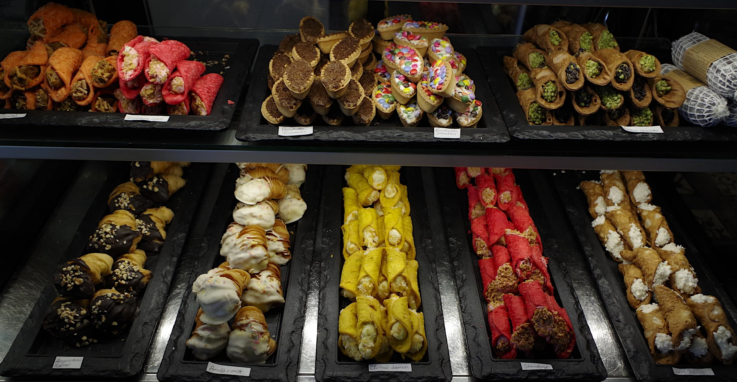 image of many canolli arranged in a chiller display unit