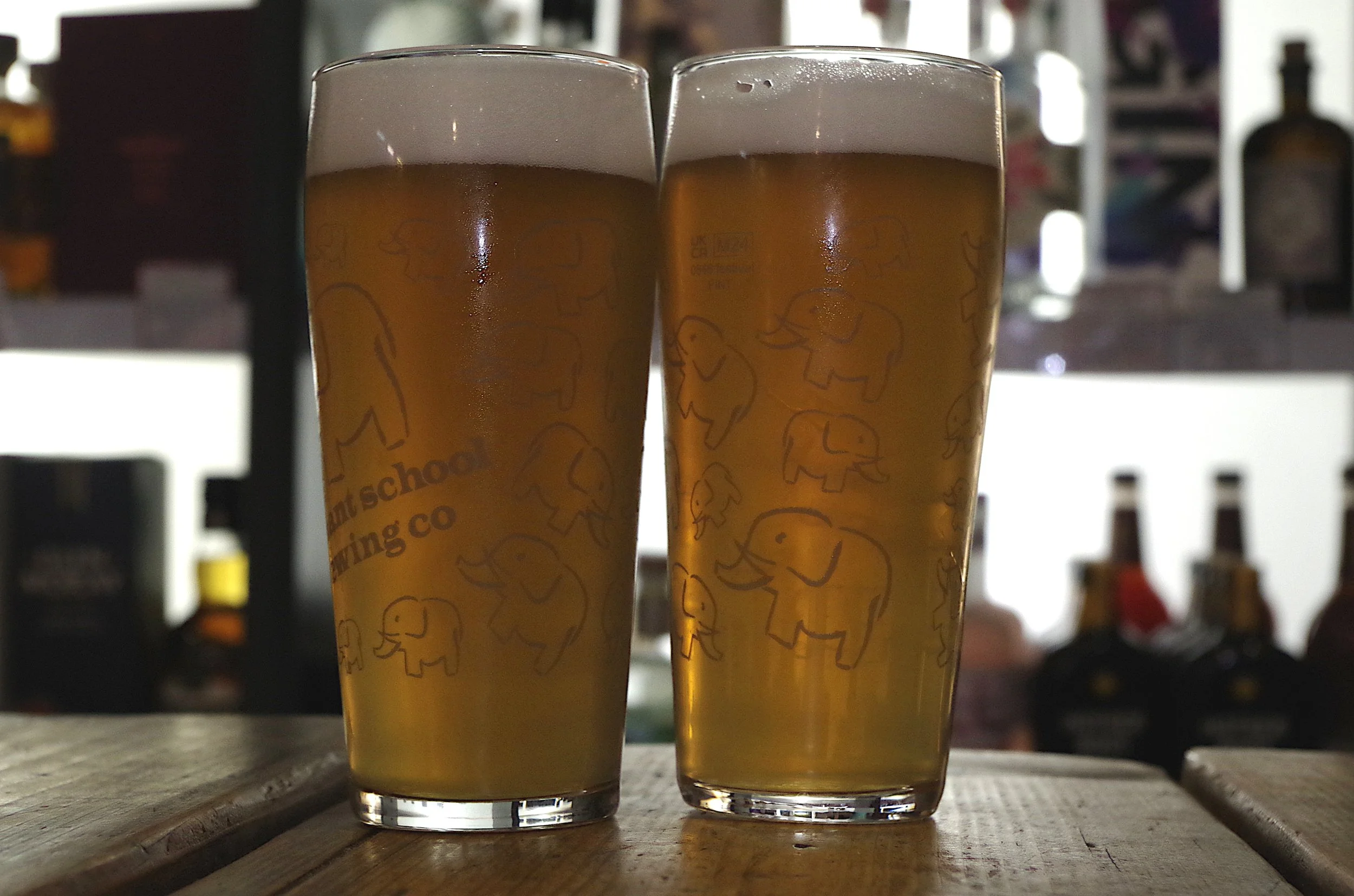 image of 2 pints of lager on a wodden table