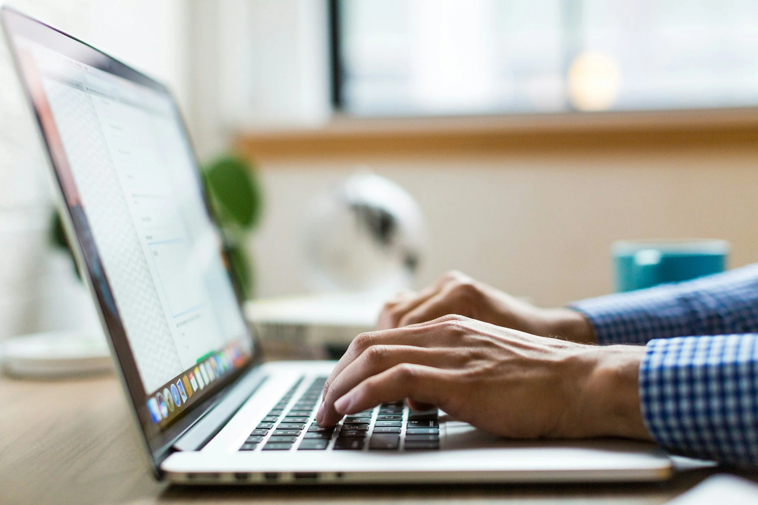 Person typing on a laptop — reaching out to Science of Teams for a discovery call