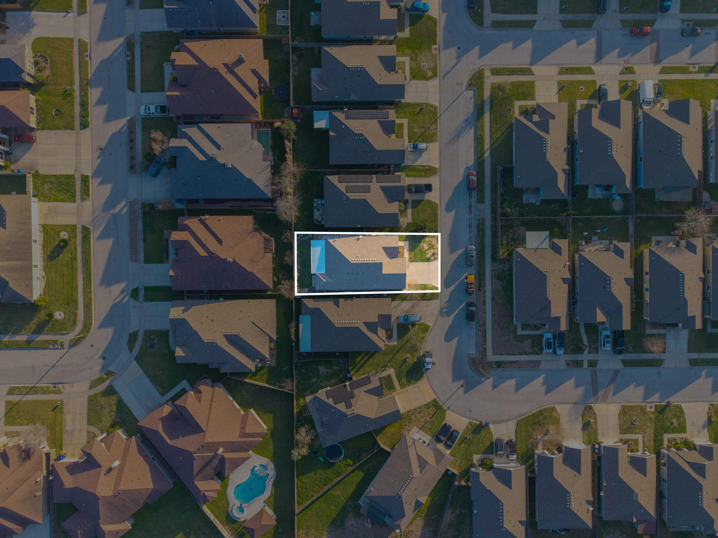 Drone photo with property boundary overlay showing a residential lot for real estate marketing.