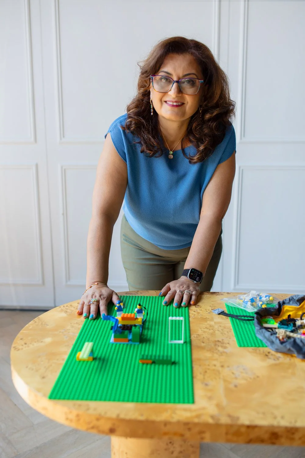 Coach Lucy smiling & using LEGO Smartplay tools