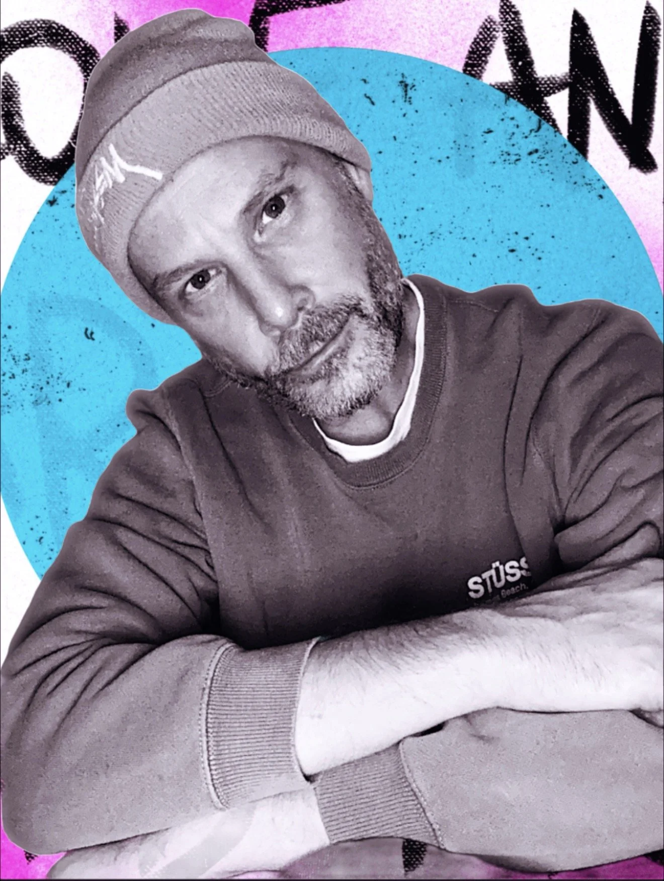 A black-and-white photo of a man with a beard, wearing a beanie and a sweatshirt with the word 'STÜSSY' visible, sitting with arms crossed in front of a background featuring a large blue circle and colorful graffiti.