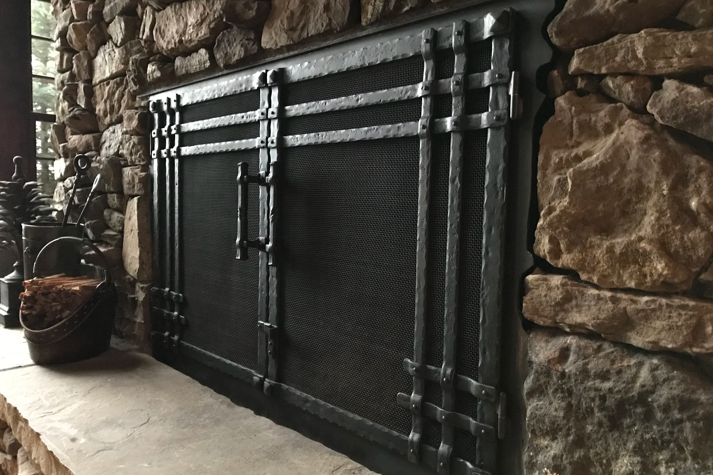 Handcrafted Forged Fireplace Screen – Handcrafted by Red Iron Studio, this custom forged steel fireplace screen features a timeless hammered finish with artisan-forged details that bring warmth, character, and lasting durability to any fireplace. Des