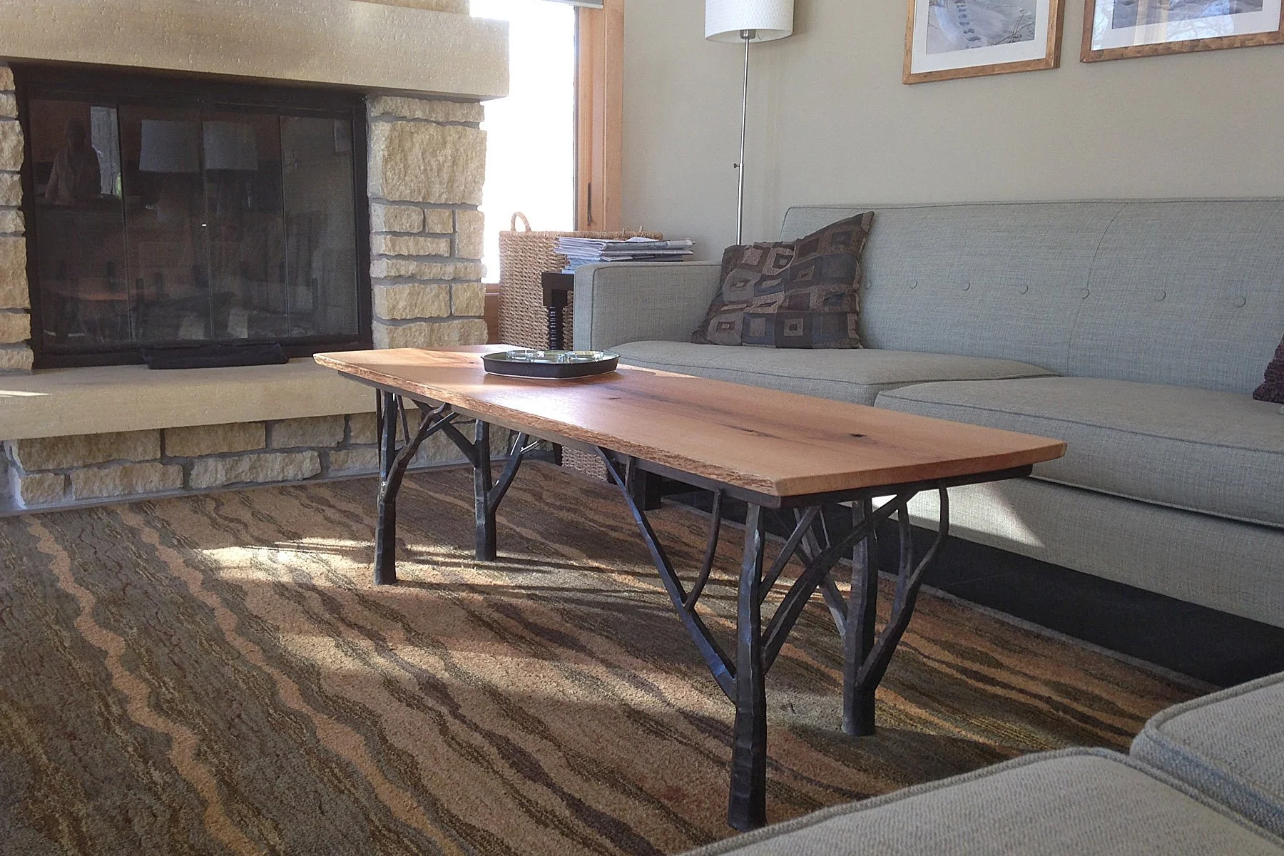 This handcrafted coffee table pairs a live-edge wood slab top with sculptural, hand-forged iron branch-style legs, bringing rustic elegance and natural texture into any living space. A perfect blend of woodworking and fine metalwork, this custom coff