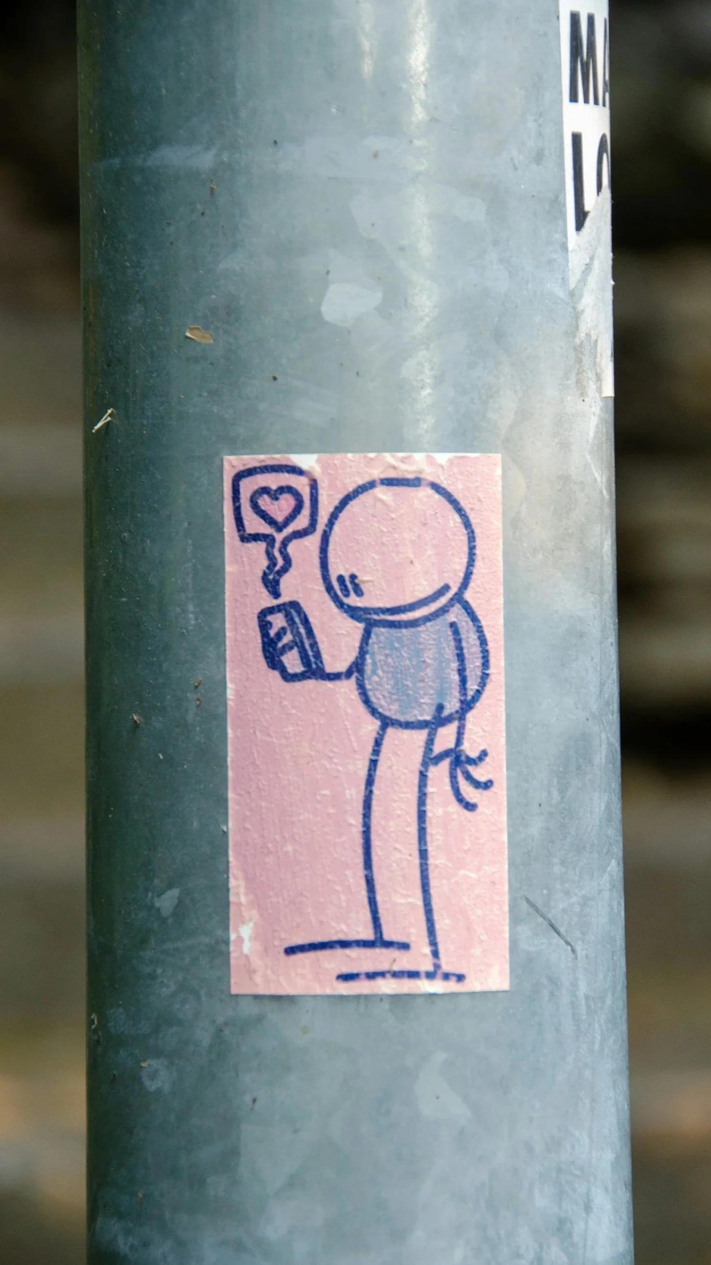 Sticker of a cartoon character drinking from a juice box, with a heart in a speech bubble coming from the character's head.