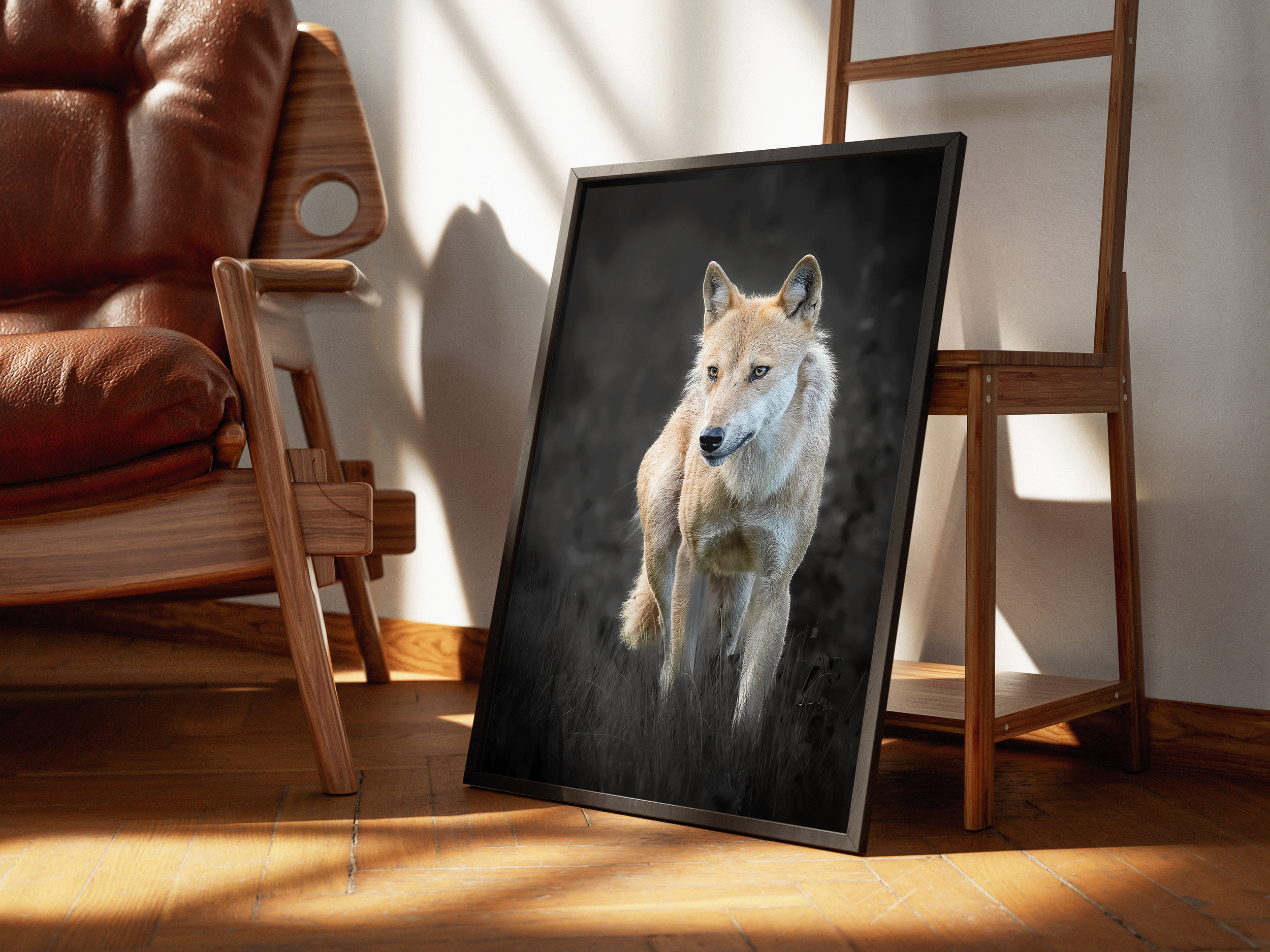 A framed picture of a wolf resting on the floor leaning against a wooden ladder in a room with wooden flooring and a brown leather chair.