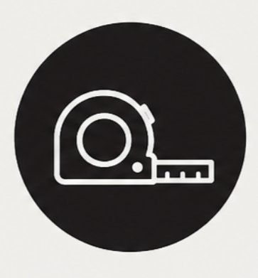 A black circle with a white outline of a tape measure and ruler.