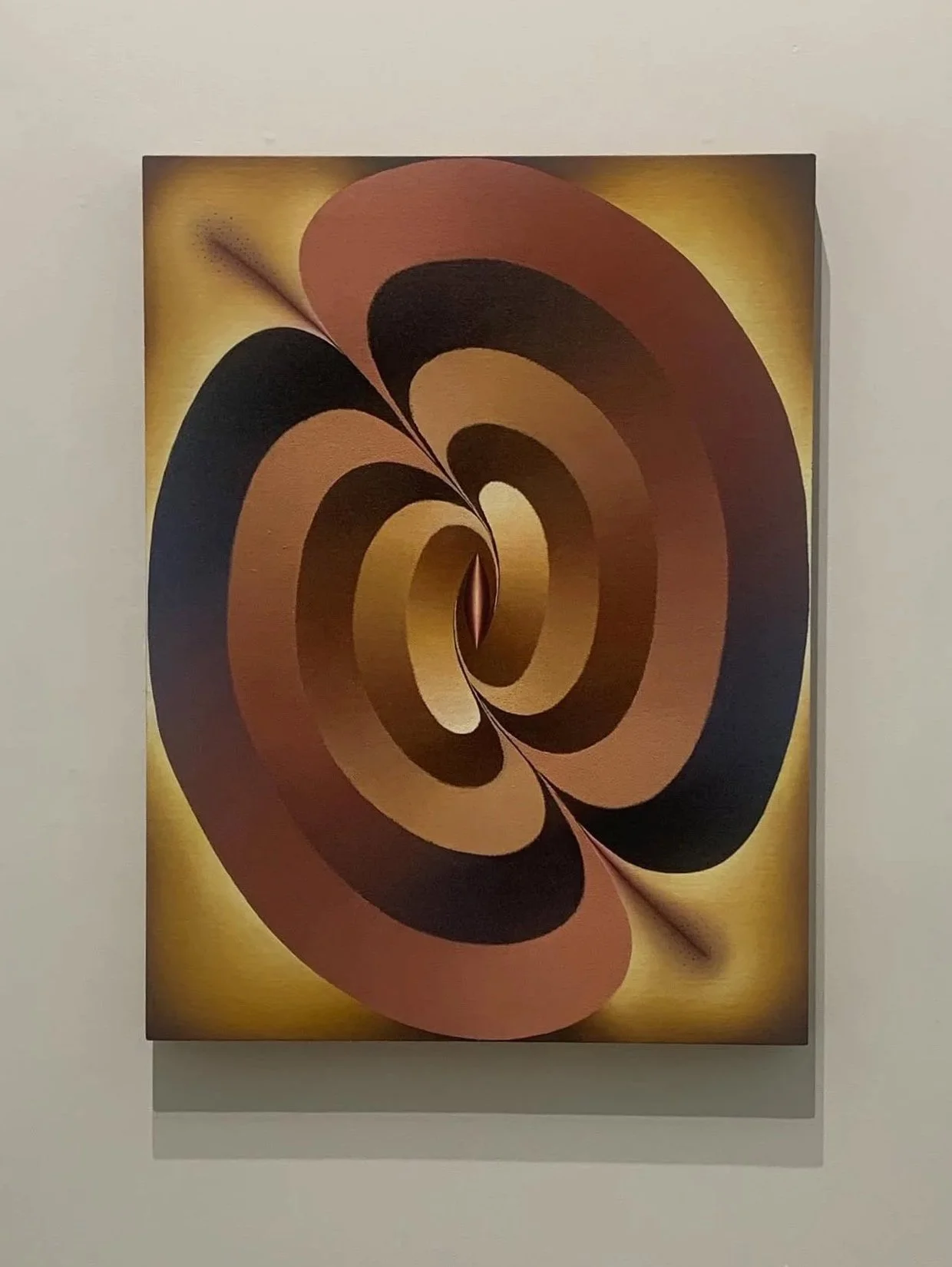 An abstract painting featuring a spiral pattern with shades of black, brown, and yellow, creating a sense of depth and motion.
