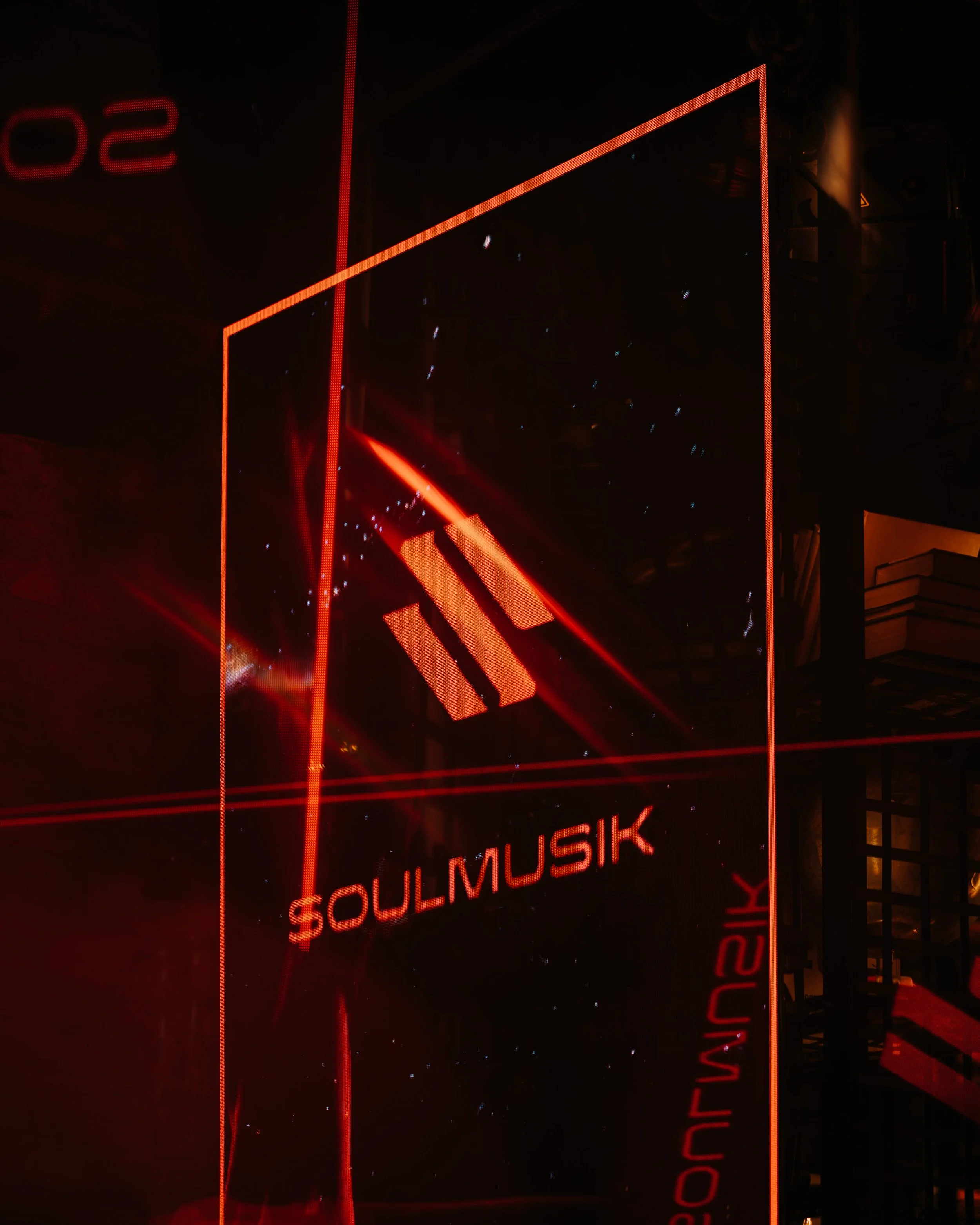 A large vertical digital display with red neon lights, showing the words 'SOULMUSIC' in the lower part, and some other partially visible text and design elements.