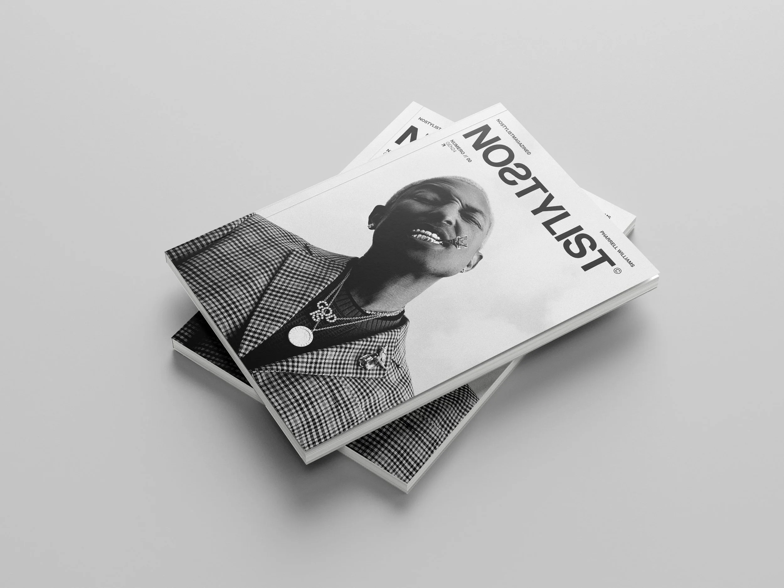 Close-up of a magazine titled 'NOSTYLIST' featuring a black and white photo of a smiling woman with short hair, wearing a checkered blazer and jewelry, placed on a plain white surface.
