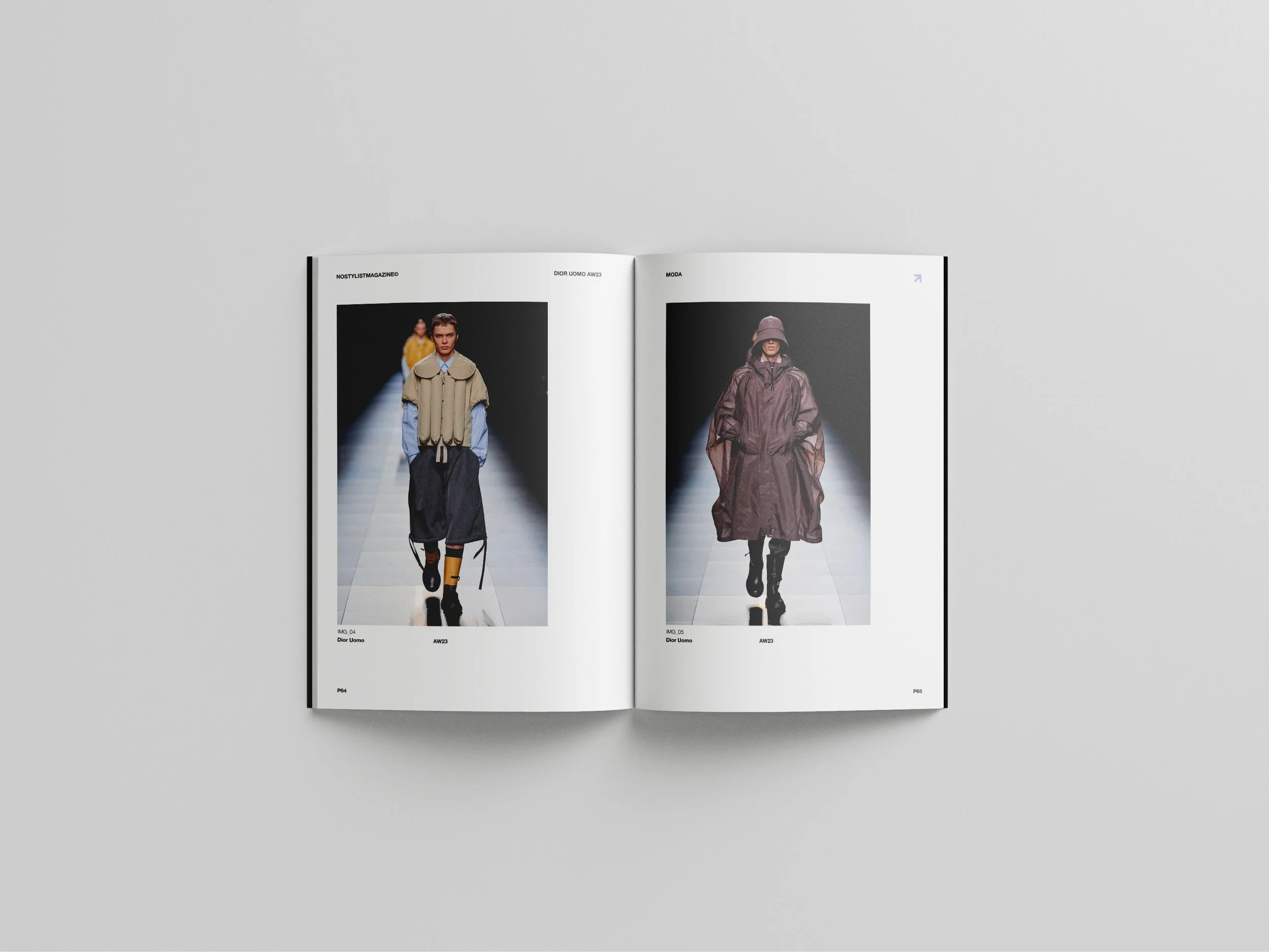 An open magazine displaying two pages of fashion runway photos, showing models walking in designer clothing on a runway.