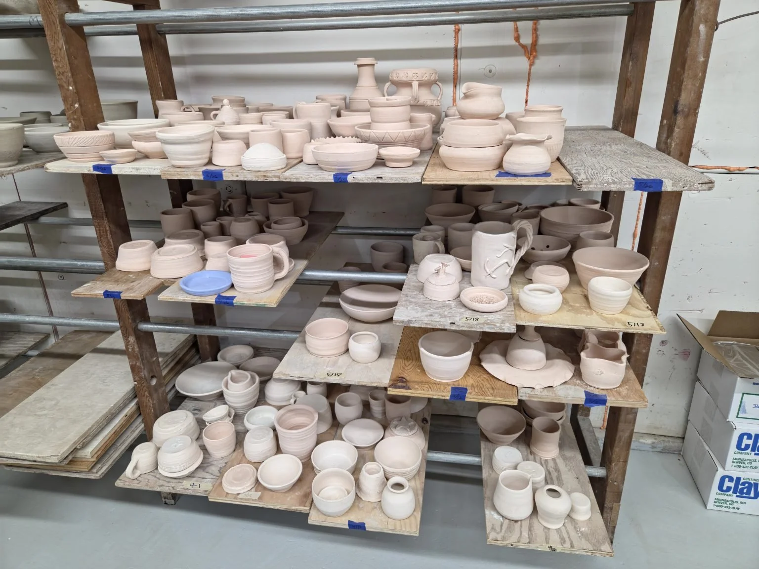 shelves full of unglazed clay pots