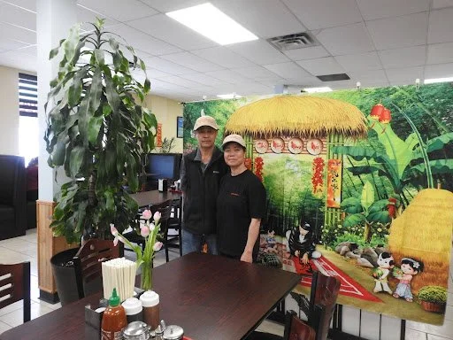 Hien Nguyen (left) and Tien Phan (right) standing inside the Pho Pasteur restaurant.