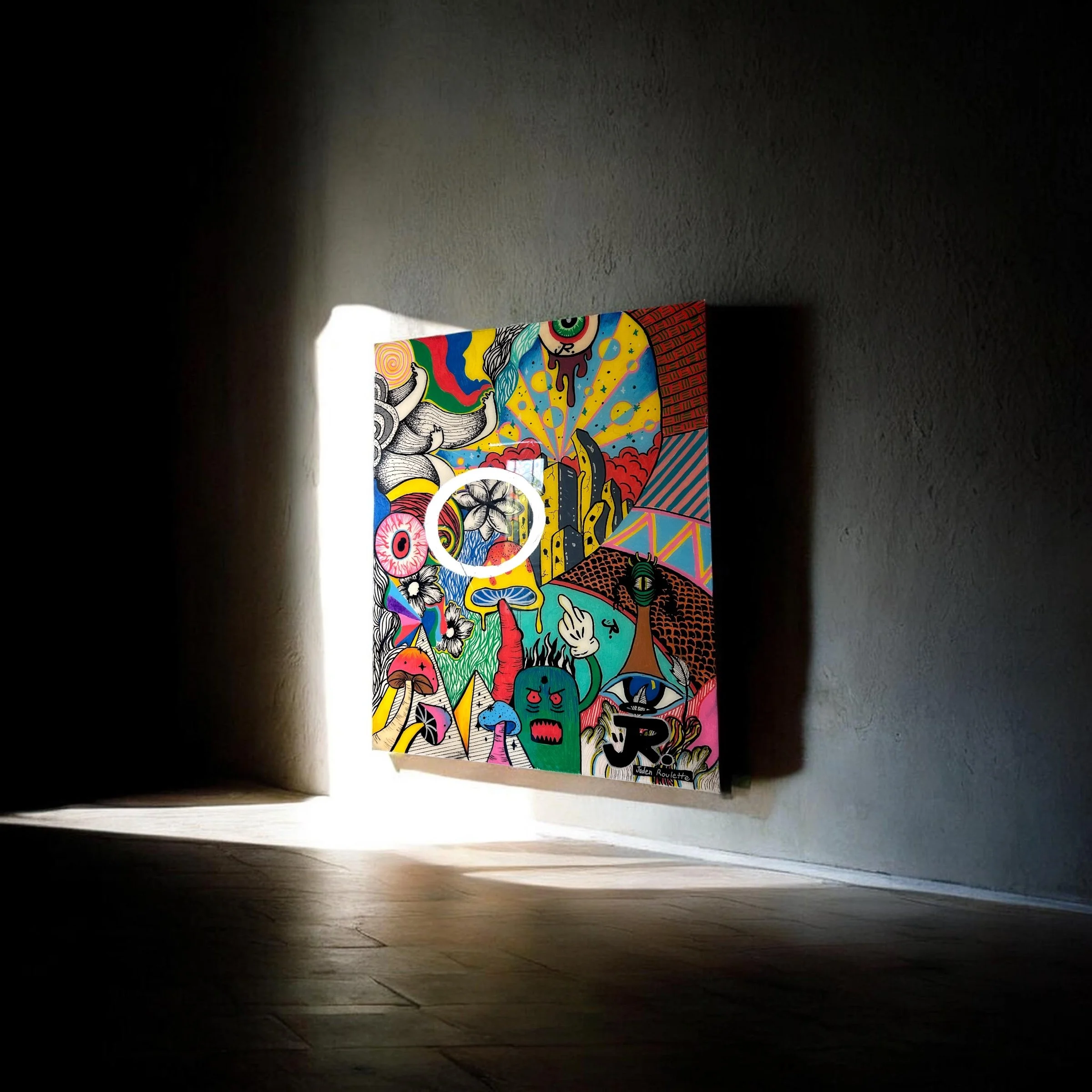Colorful graffiti mural on a wall, visible in a dark room illuminated by a small light at the top of the image.