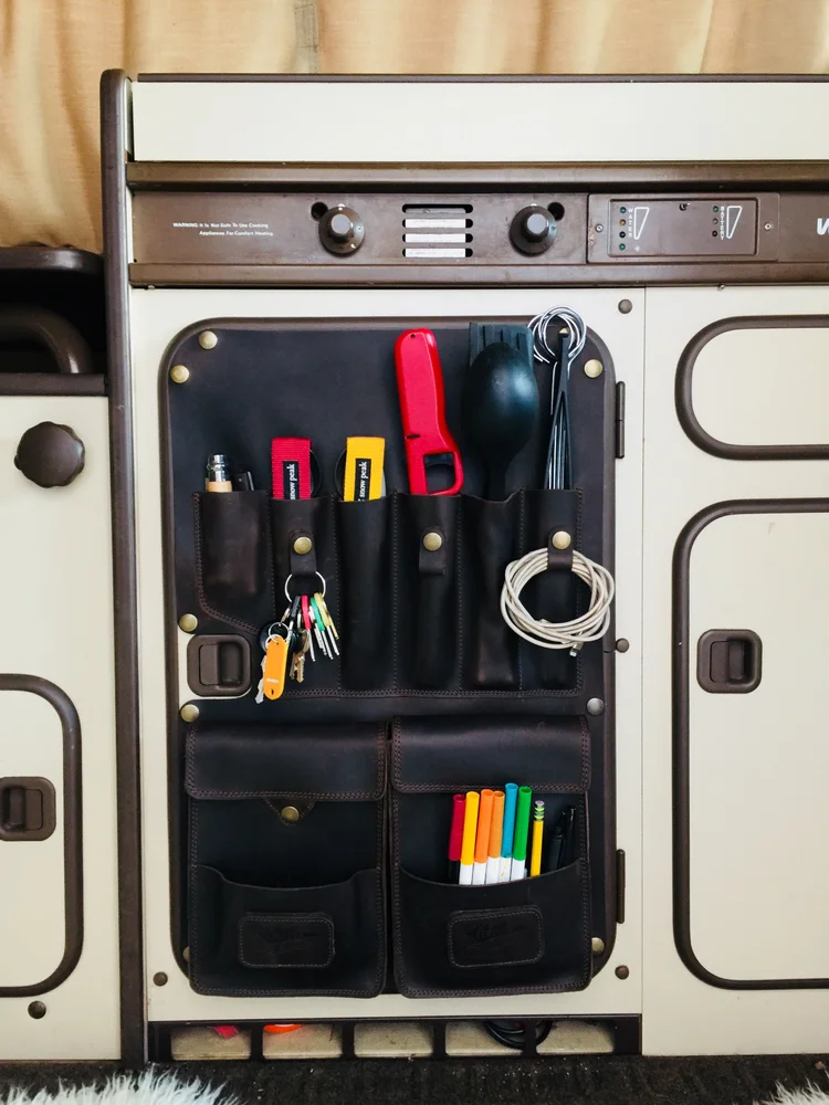 Westy Cocina leather kitchen organizer holding utensils on a Vanagon Westfalia refrigerator door