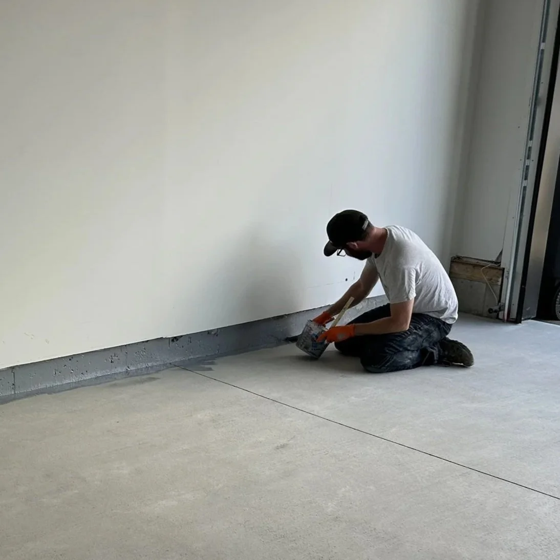 Applying polyaspartic to seal the concrete curbing.