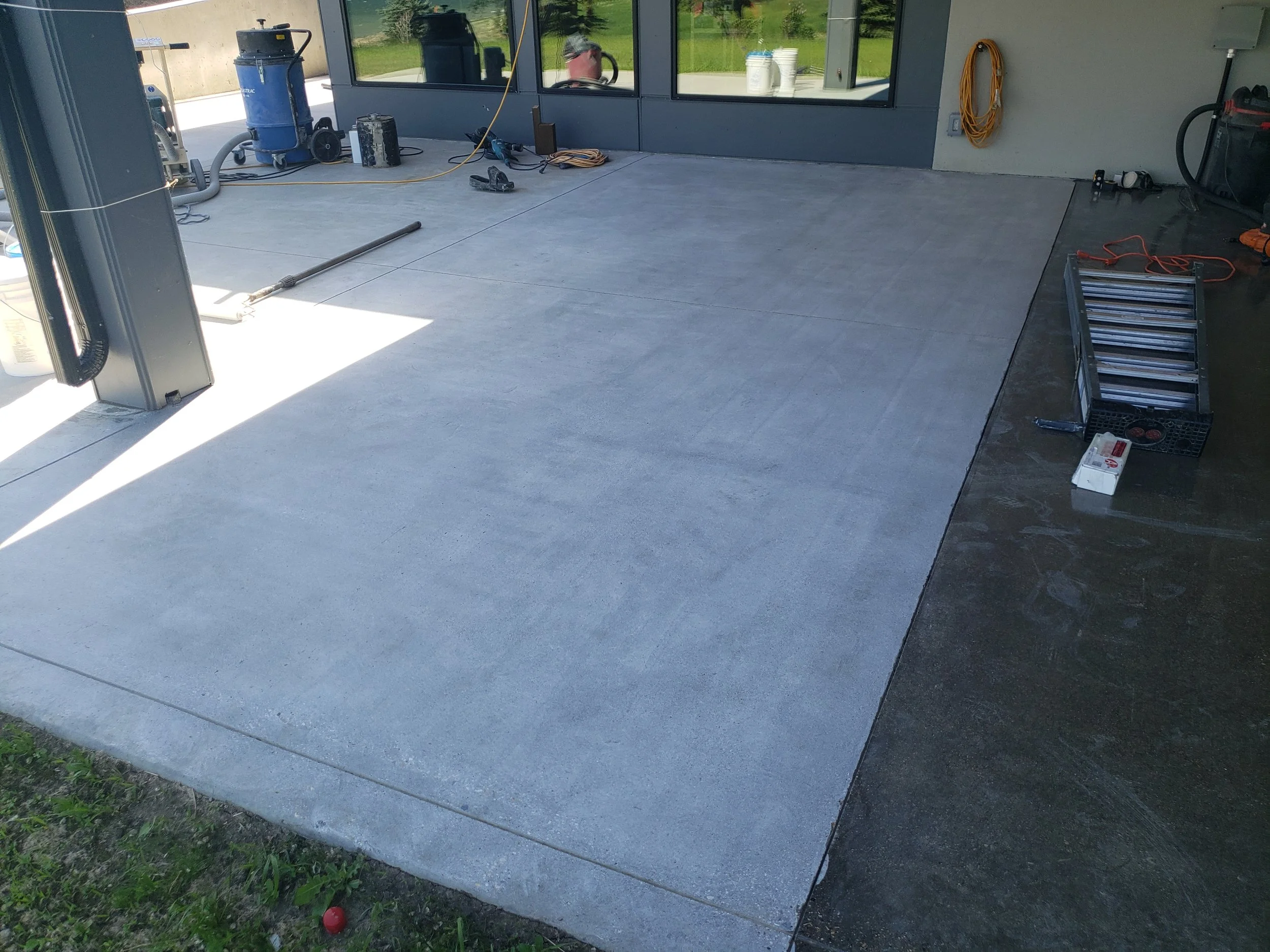Walk-out basement patio concrete pad before any finishes added. Bare concrete. 