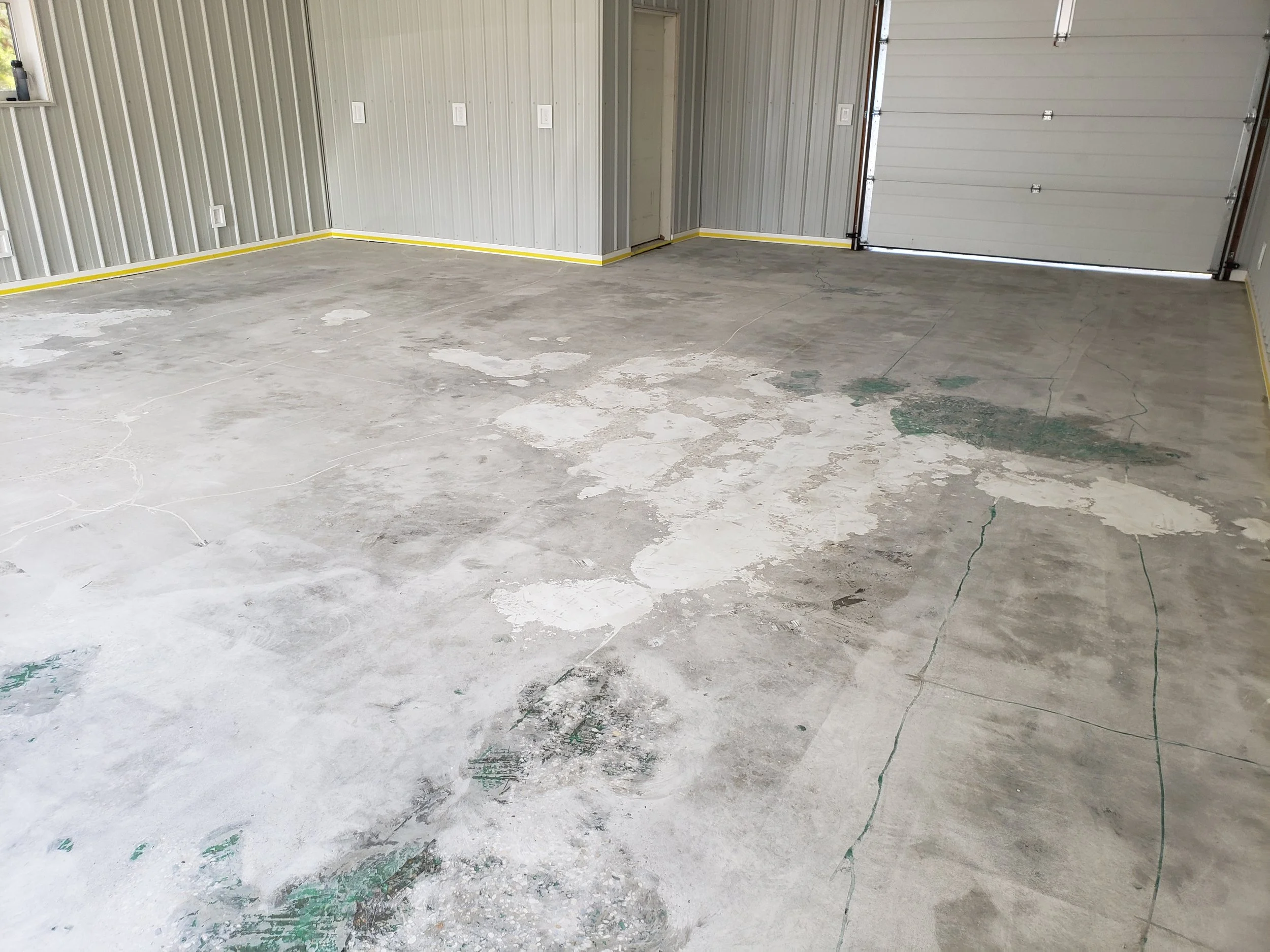 	
Garage floor with pitting and spalling, repaired and grinded. 