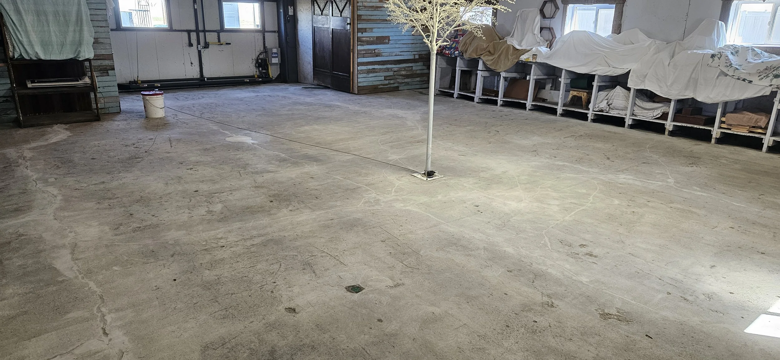 BEFORE - Bare concrete grinded and repaired.
